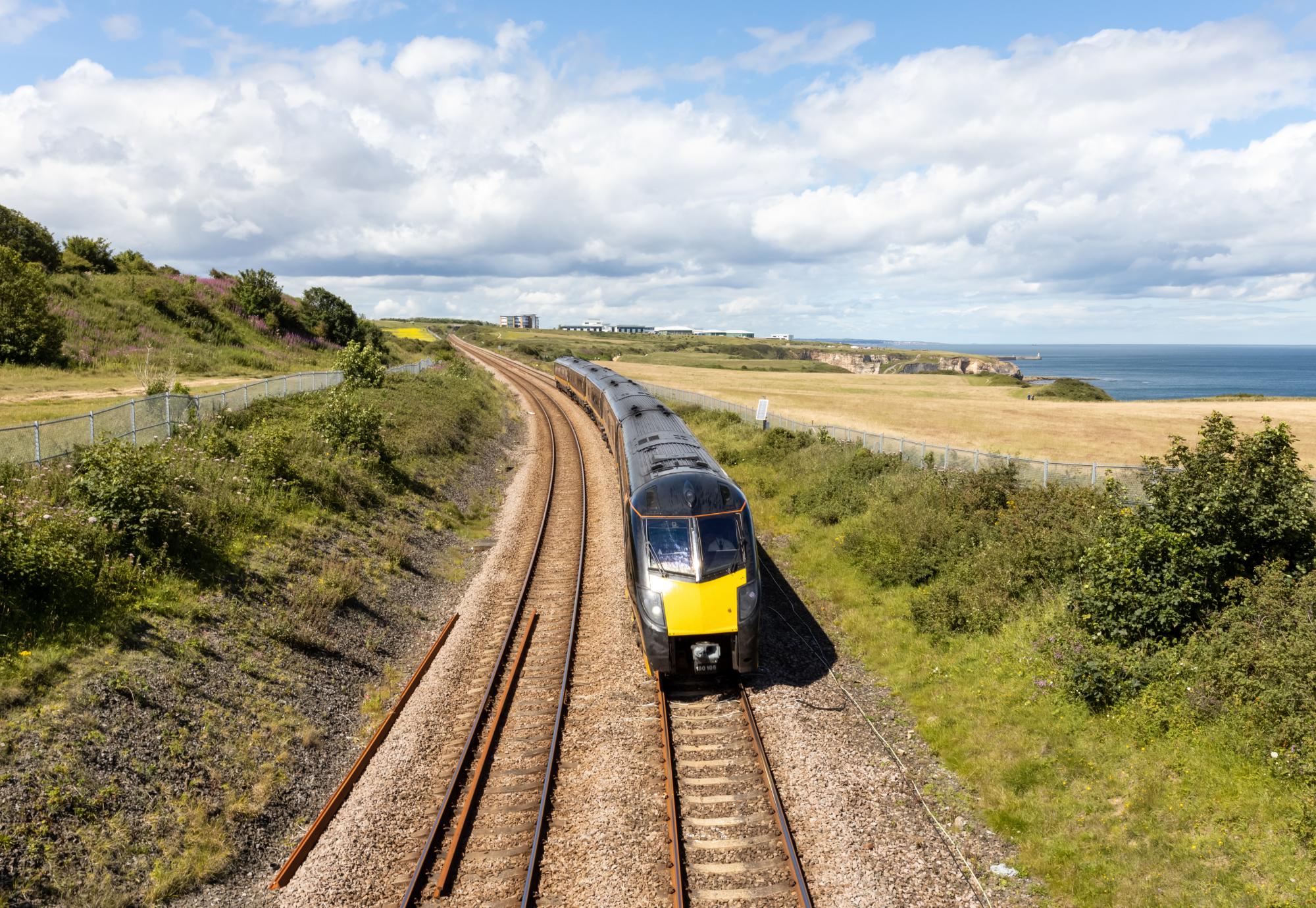 Durham Heritage Coast East Coast mainline train passing by the sea on a summer day