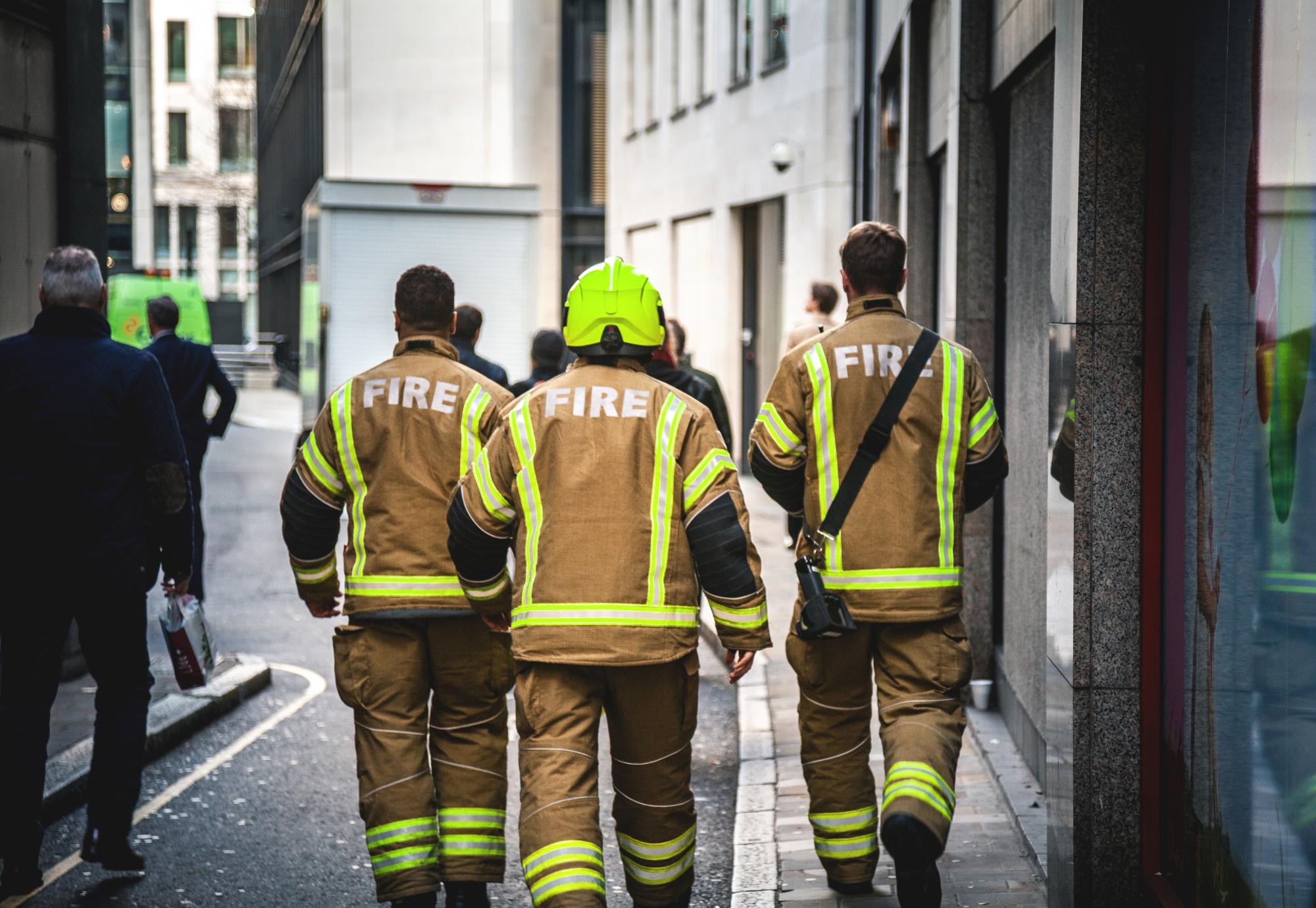 Three firefighters walking in London