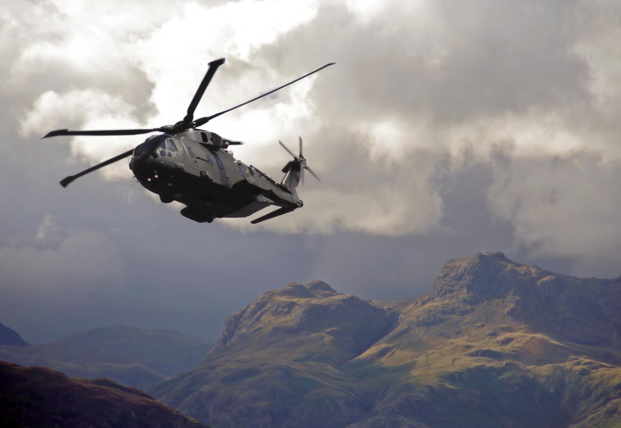 RAF Merlin helicopter hugs valleys in the lake district mountains