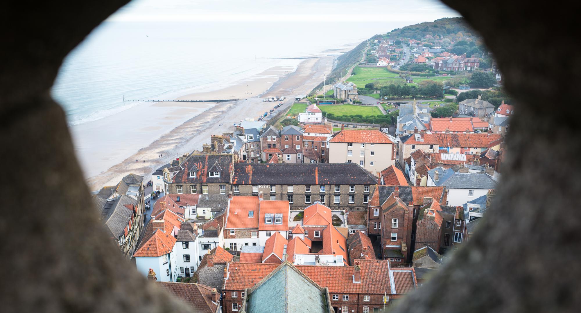 Aerial view of a town in North Norfolk through a stone window