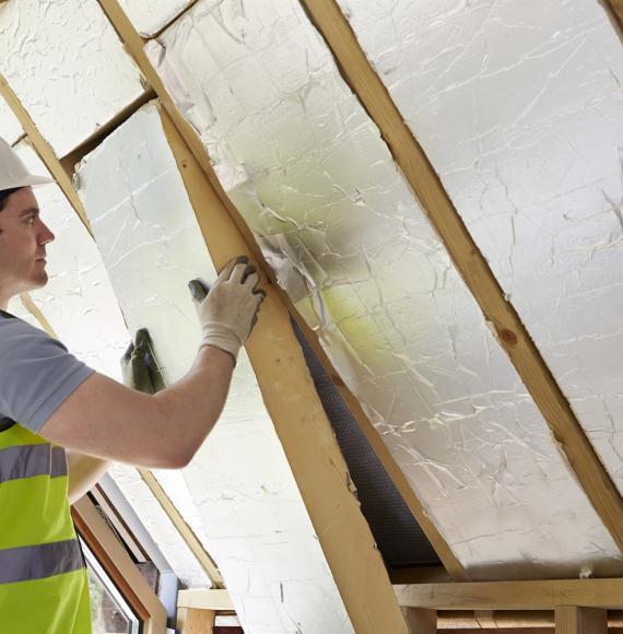 Insulation being fitted in a wall 