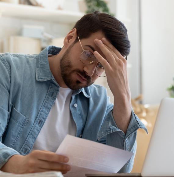 Man looking concerned at rent bill