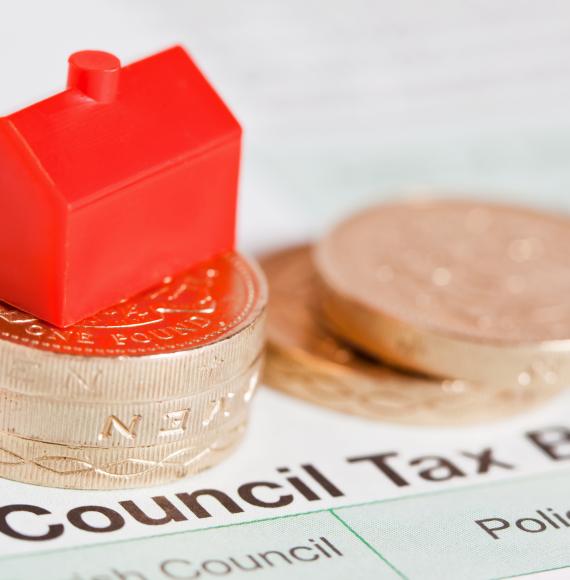 Council tax bill with coins on top.