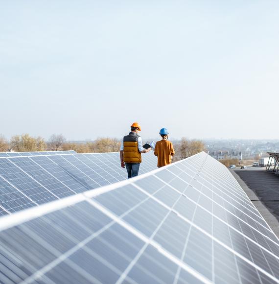Workers on a roof with solar panels