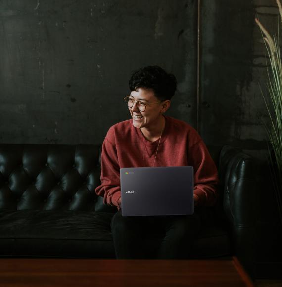 Woman sitting working on a laptop