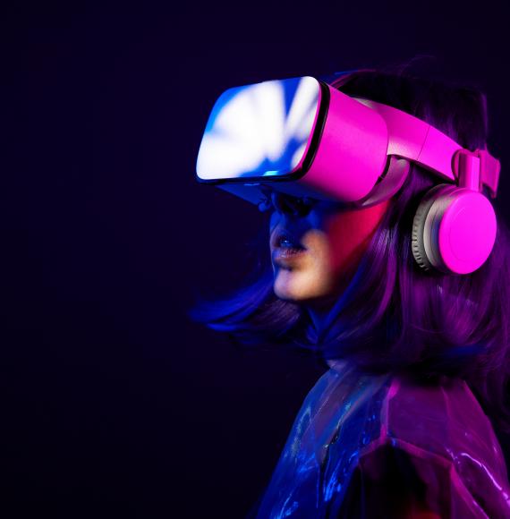 Woman in virtual reality goggle in neon colors