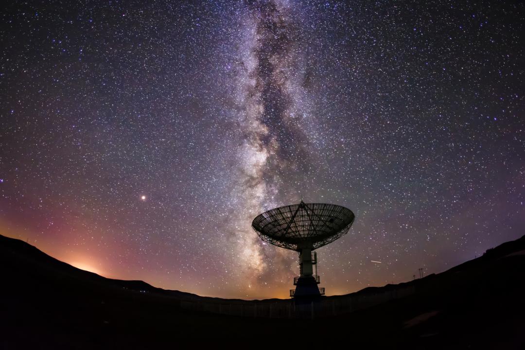 Satellite antenna pointing up to the night sky