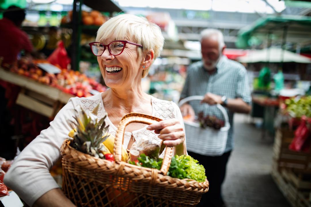 Woman holding basket of veg