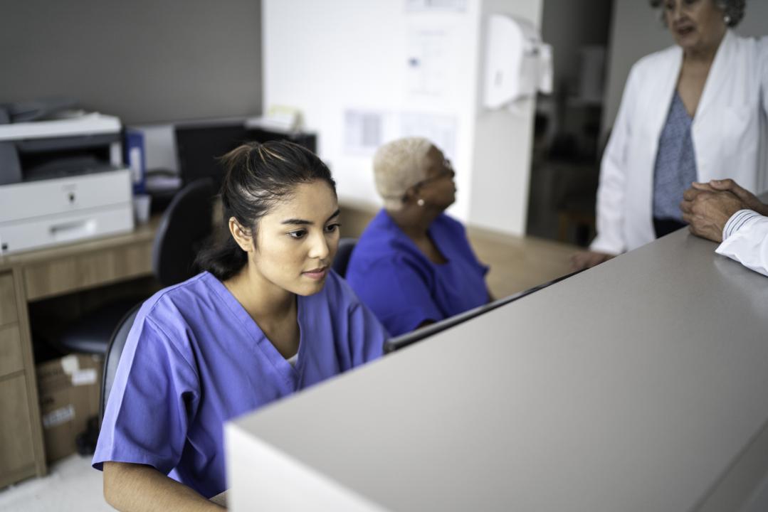 Hospital receptionist at her desk