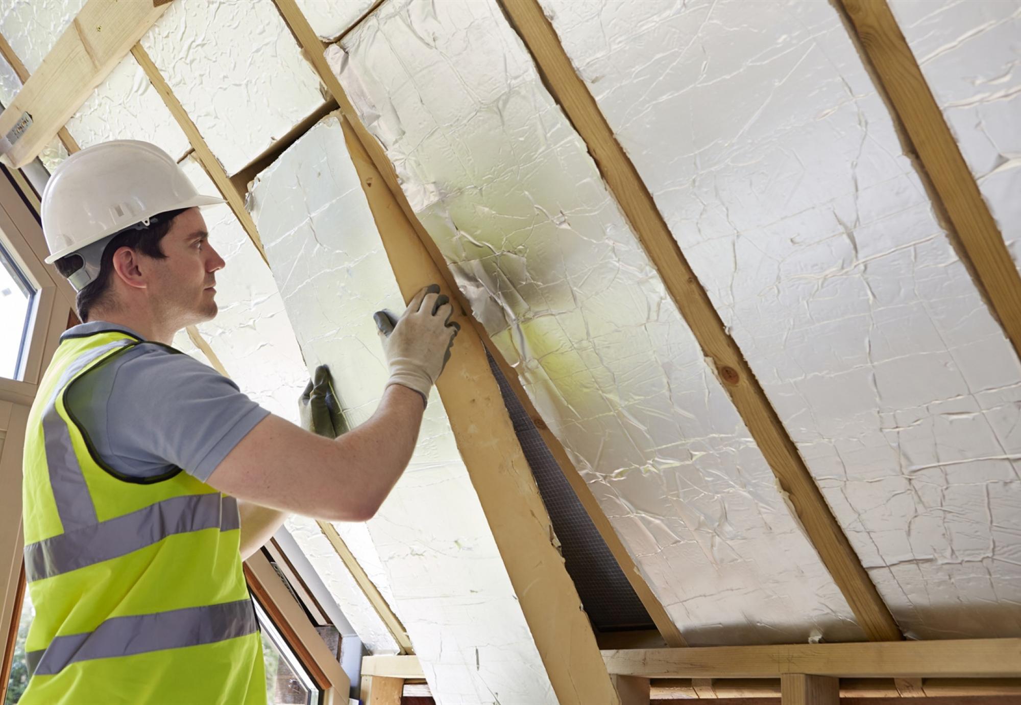 Insulation being fitted in a wall 