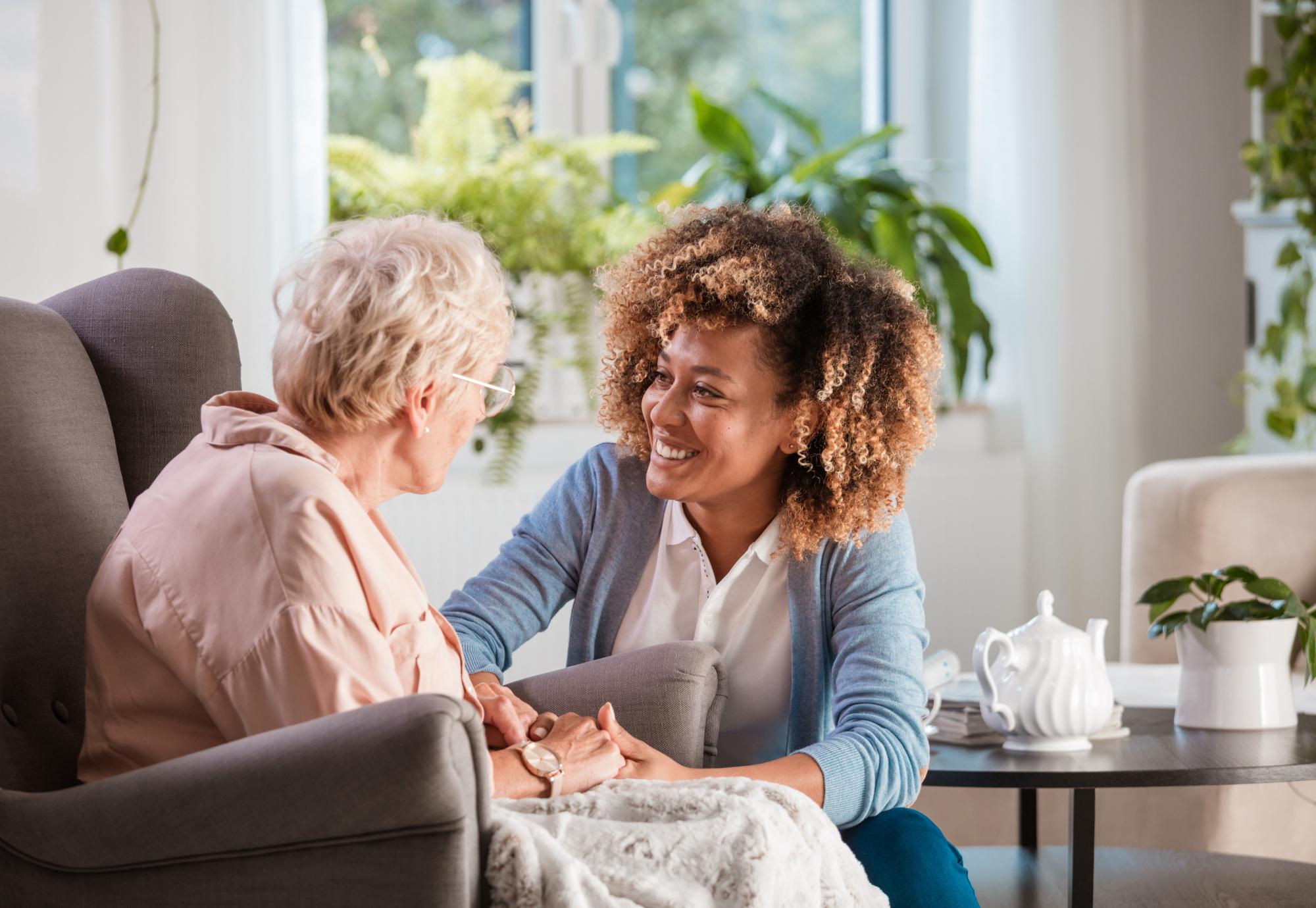 Social care worker helps elderly woman