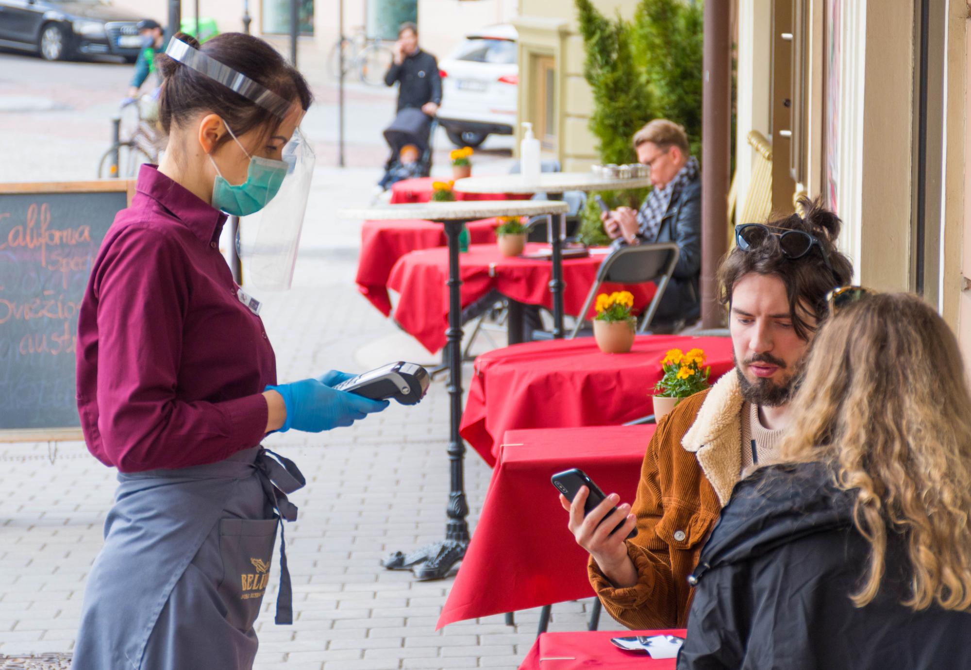 Couple being served at a bar.