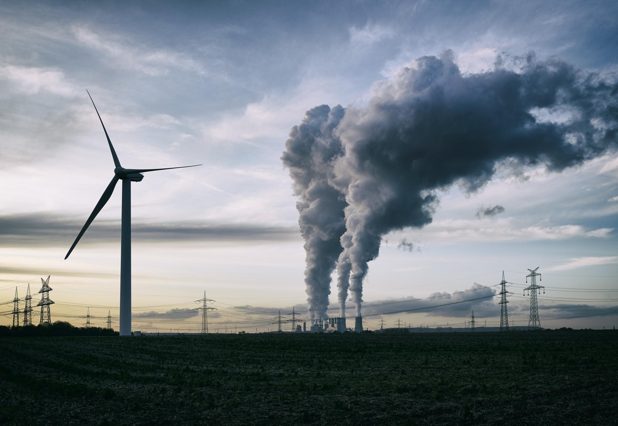 Cooling Towers next to wind turbines.