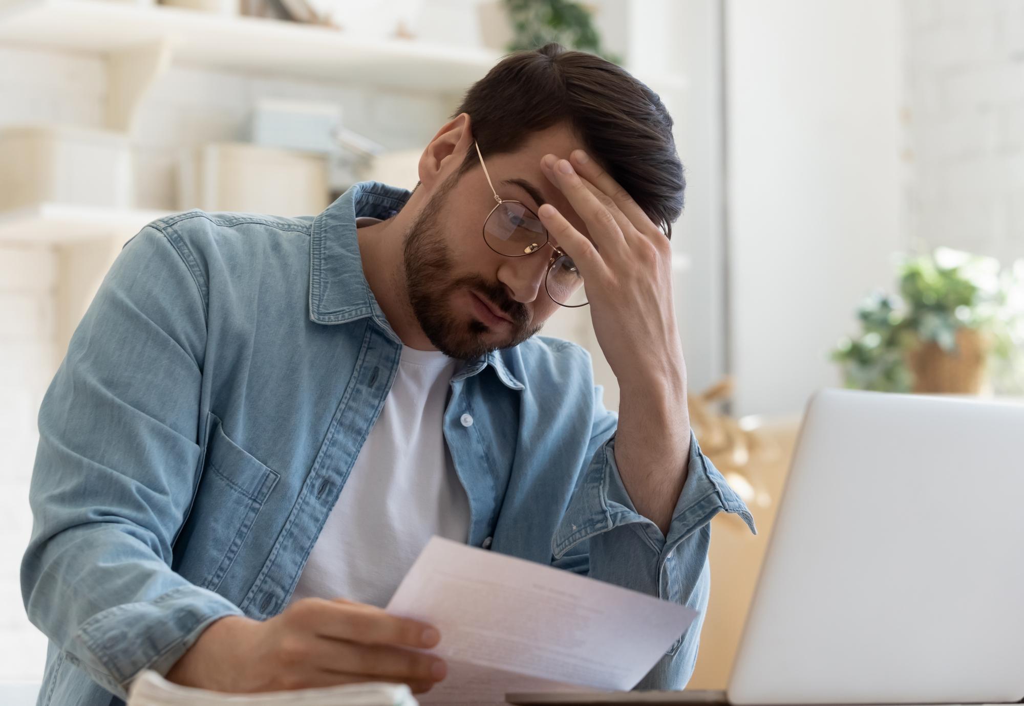 Man looking concerned at rent bill