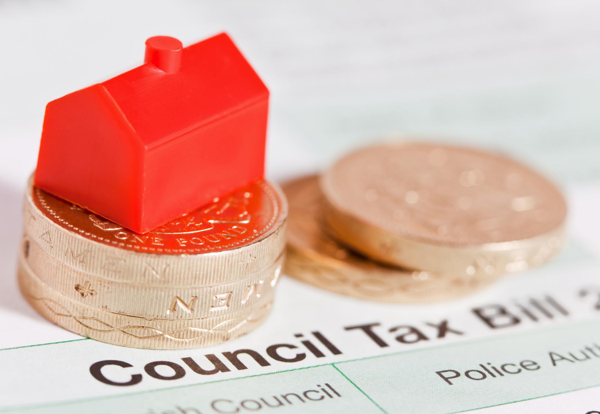 Council tax bill with coins on top.