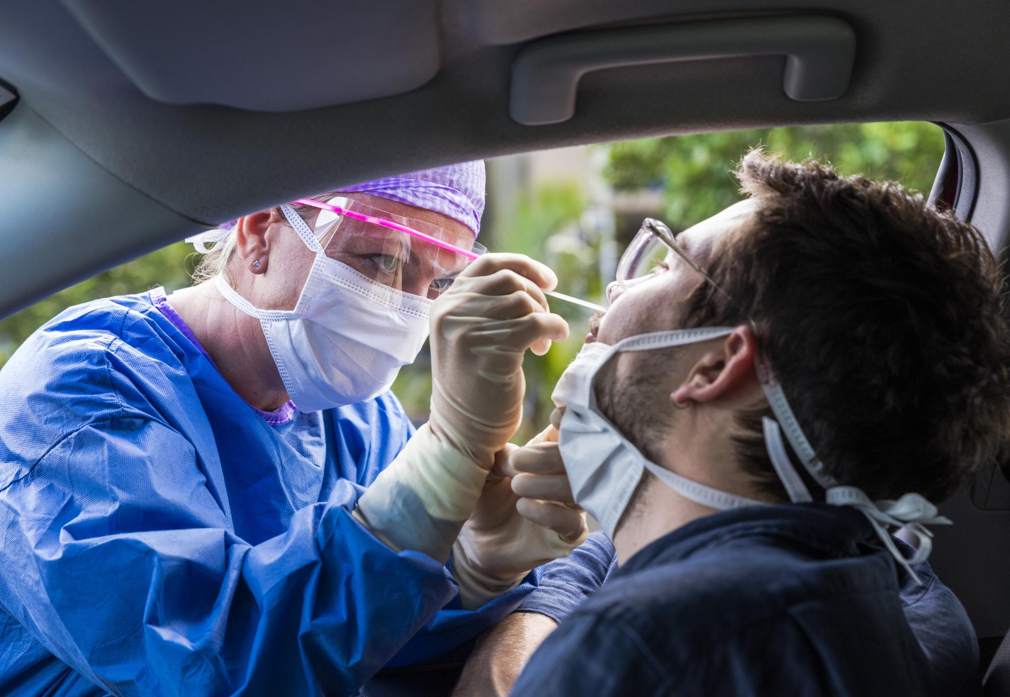 Man getting tested for Covid-19 in his car.