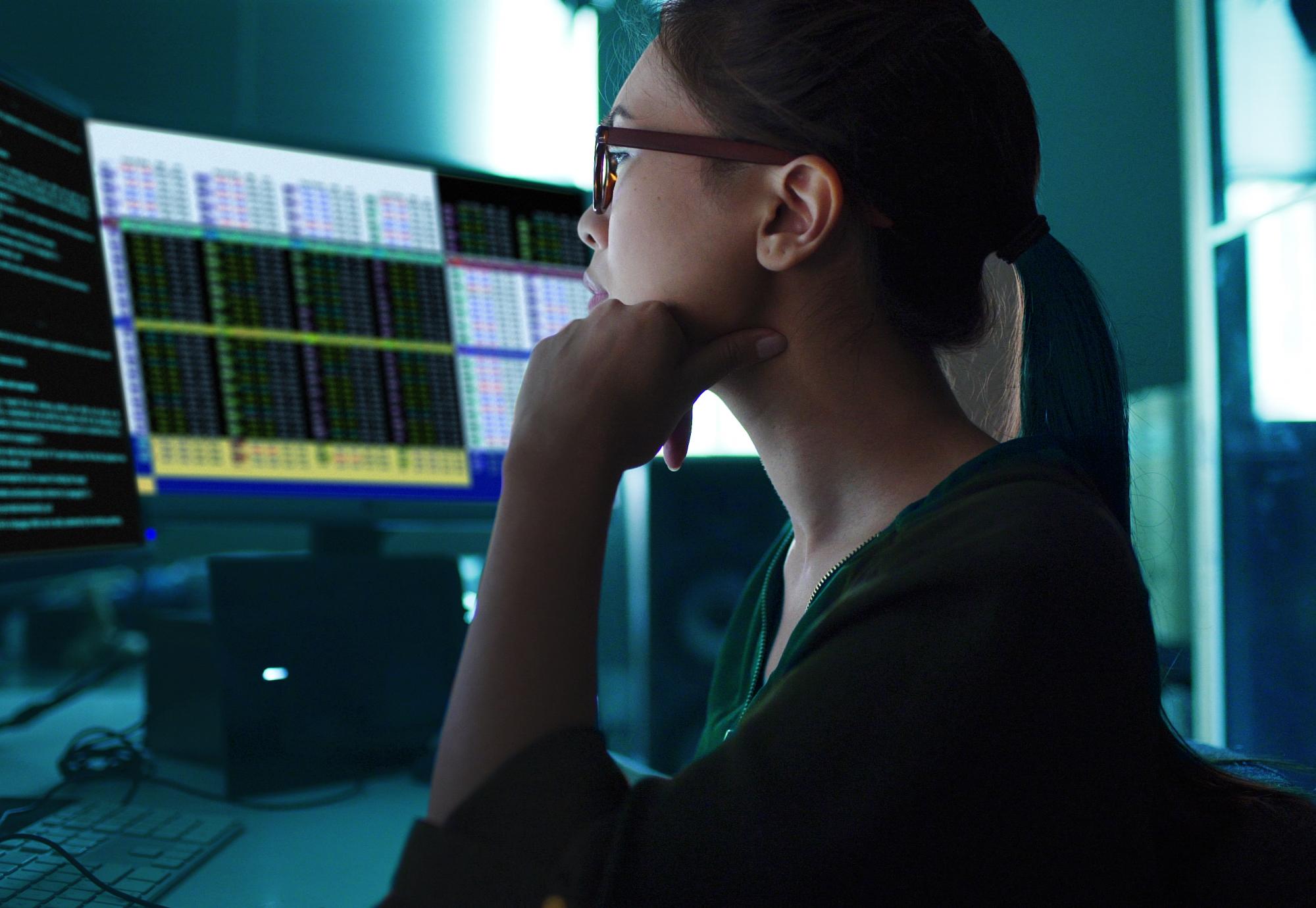 Woman sat at a computer analysing data