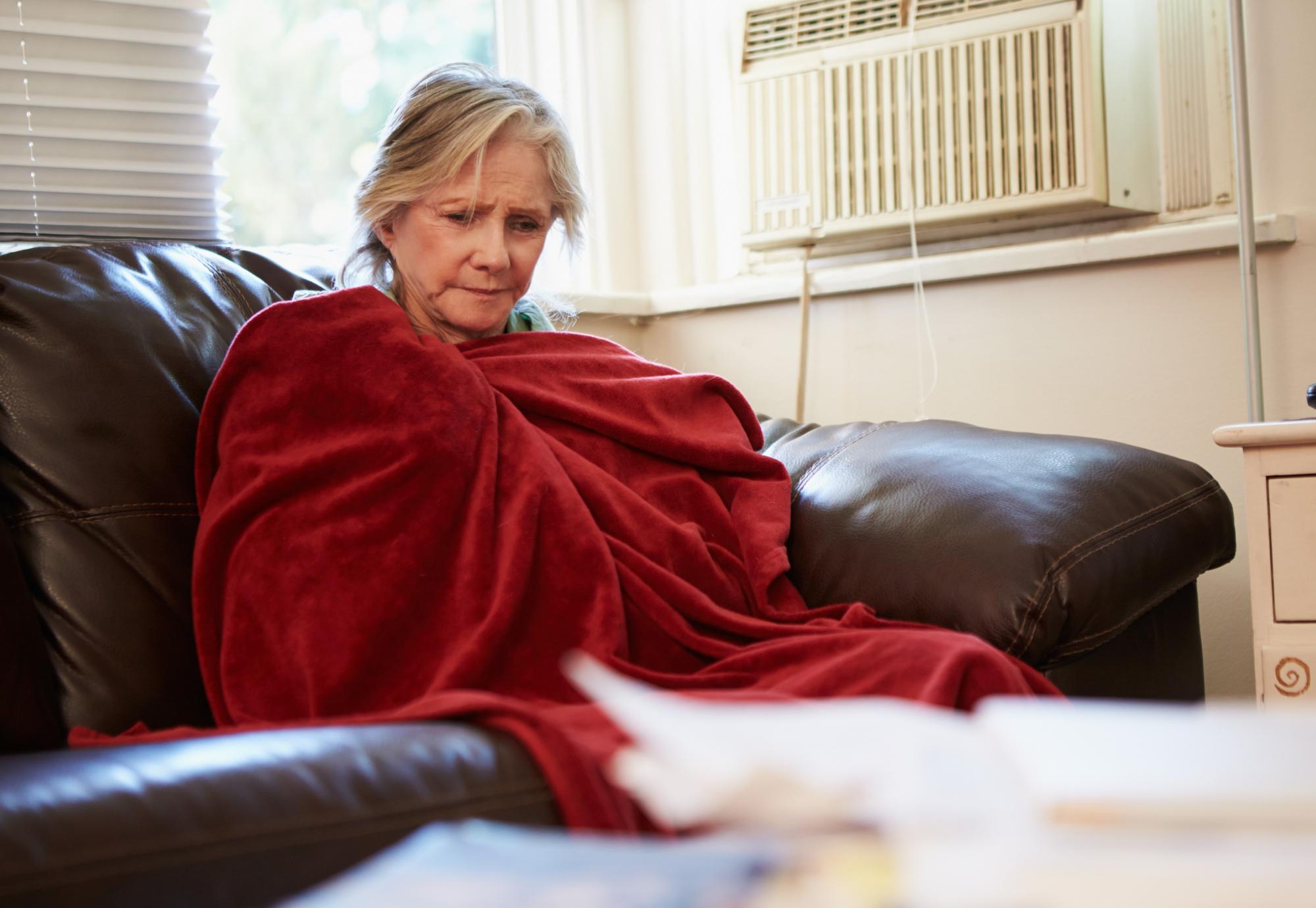 Woman is cold on couch.