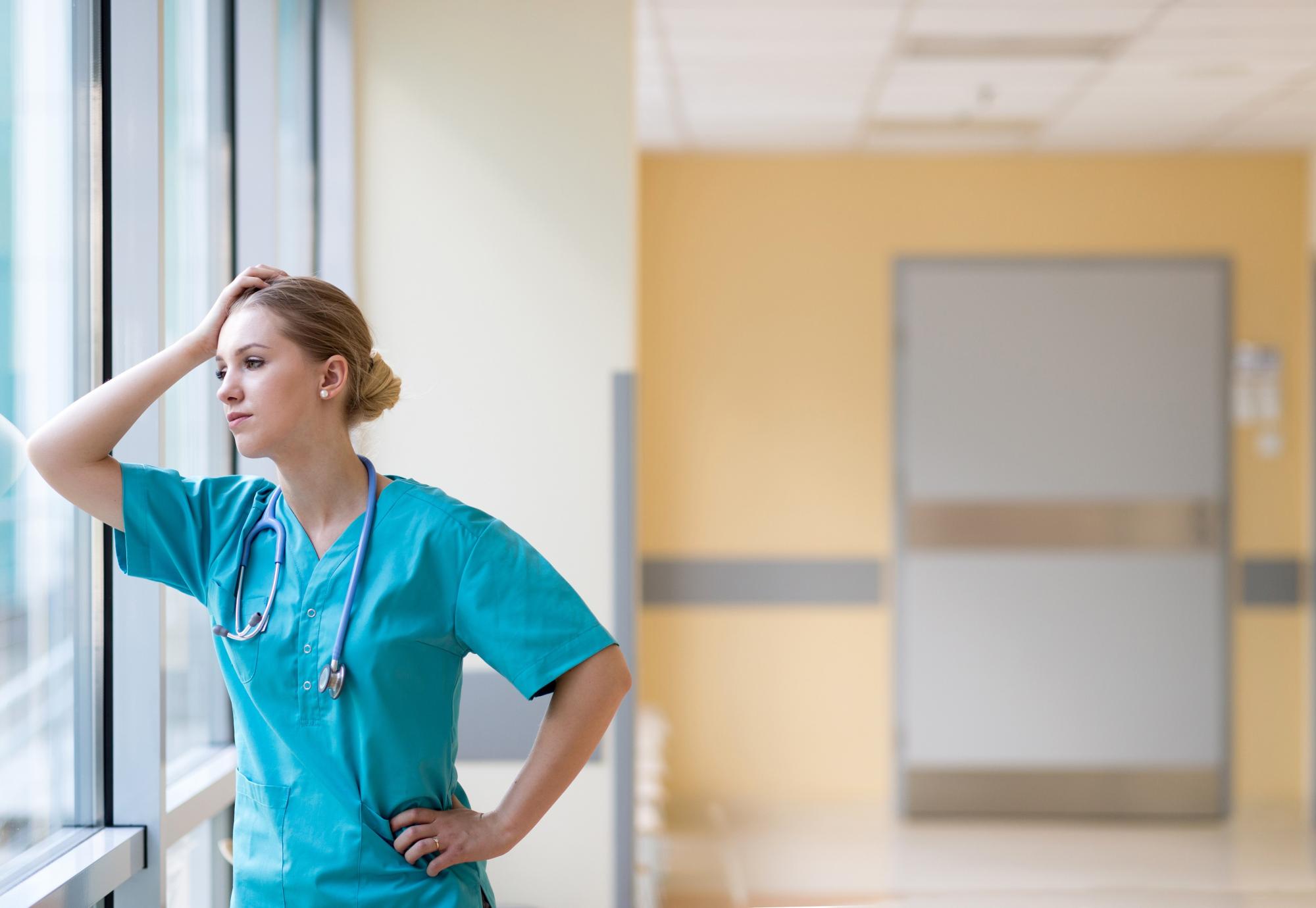 Nurse looking stressed at work