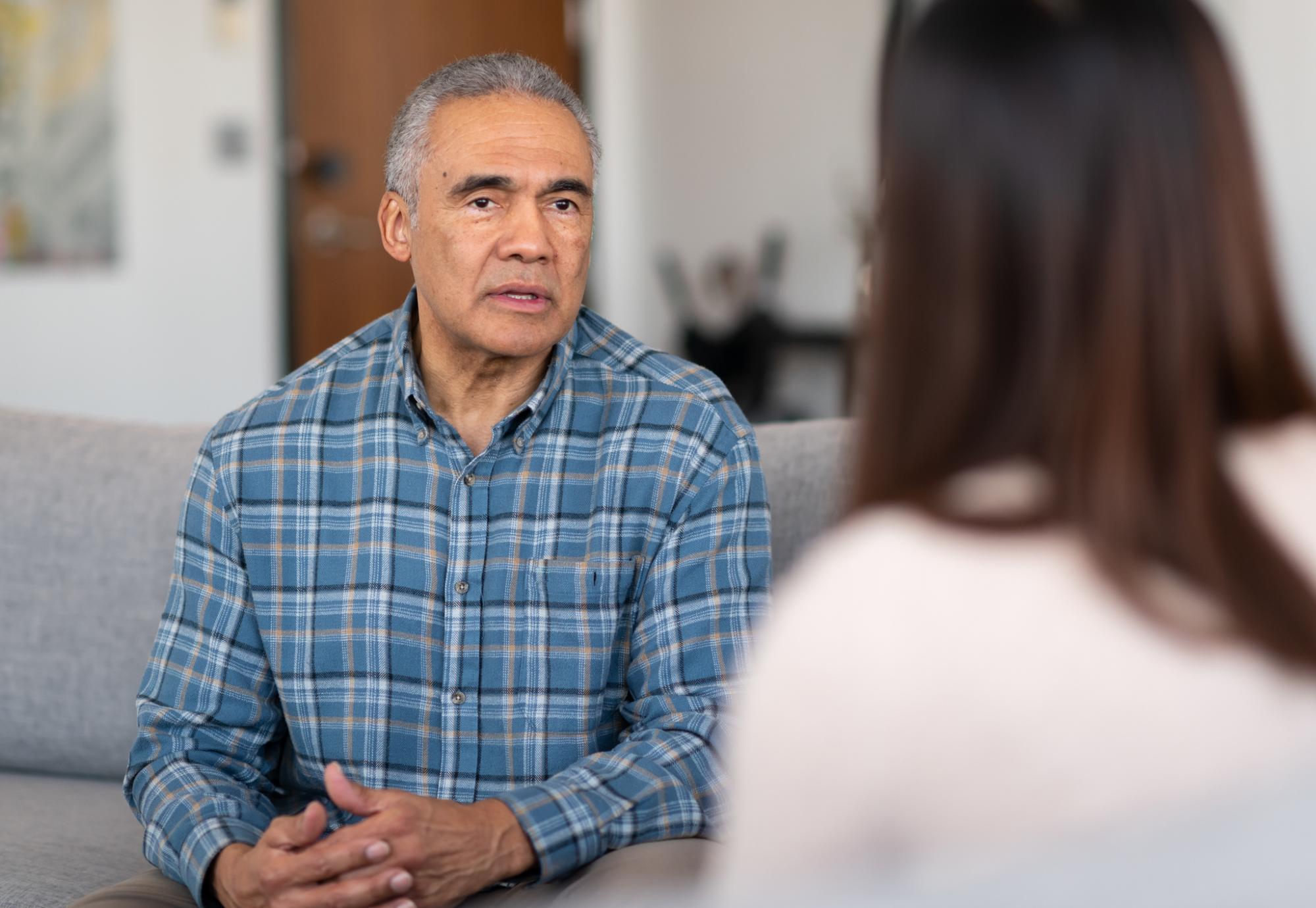 Man is spoken to by a woman to discuss his issues.