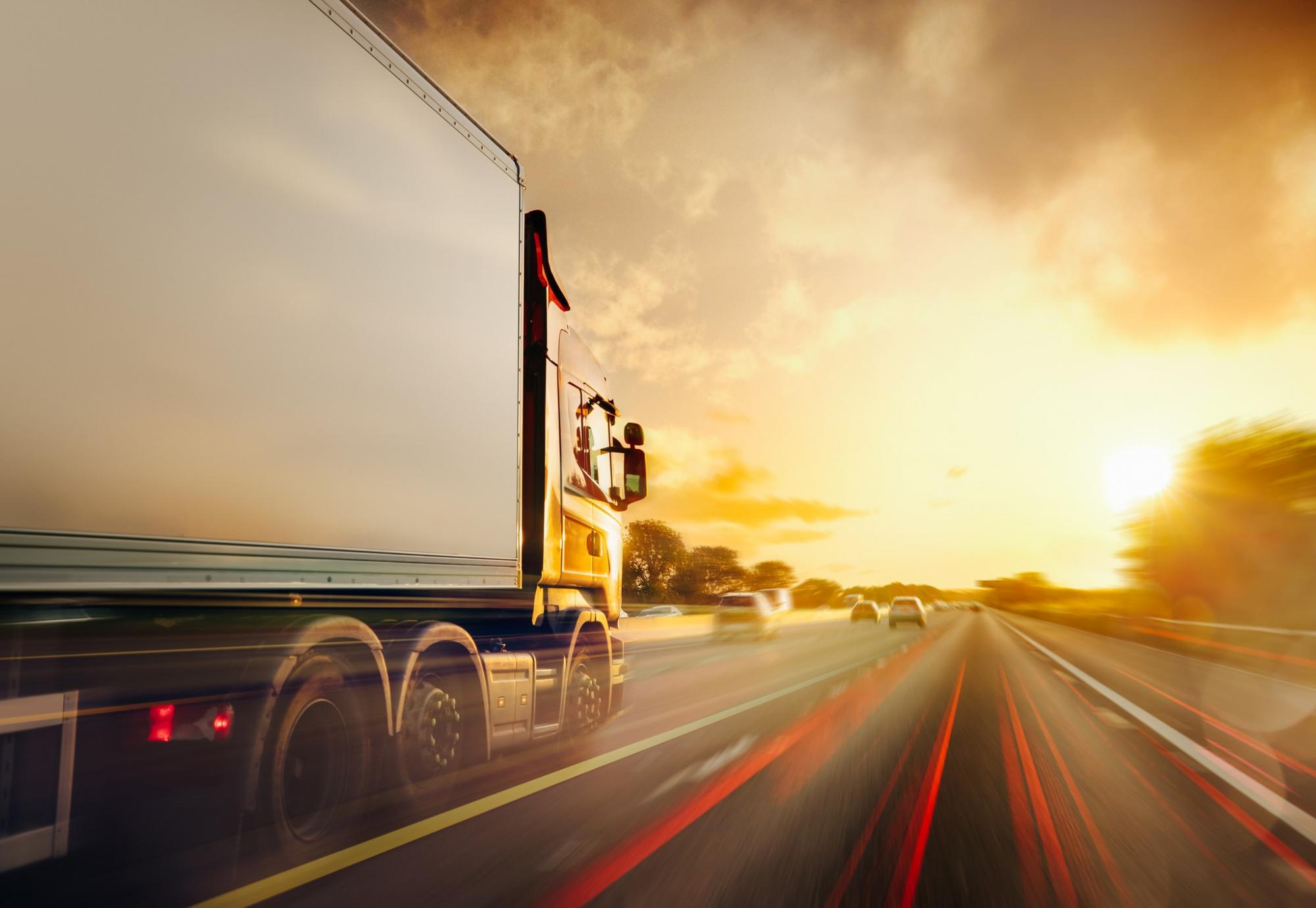 Lorry drives down the motorway with long exposure shot.