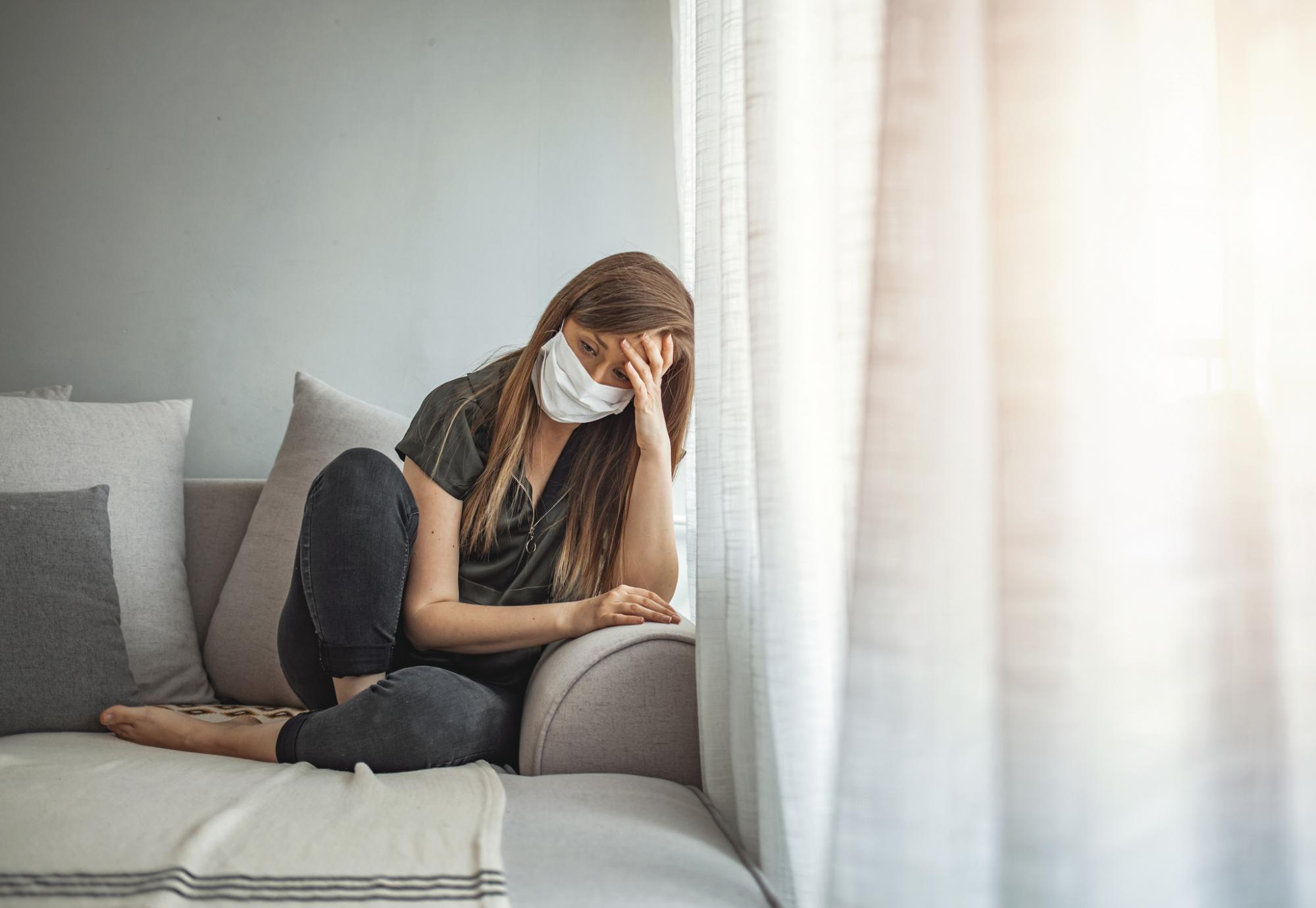 Girl isolates at home, looks sad