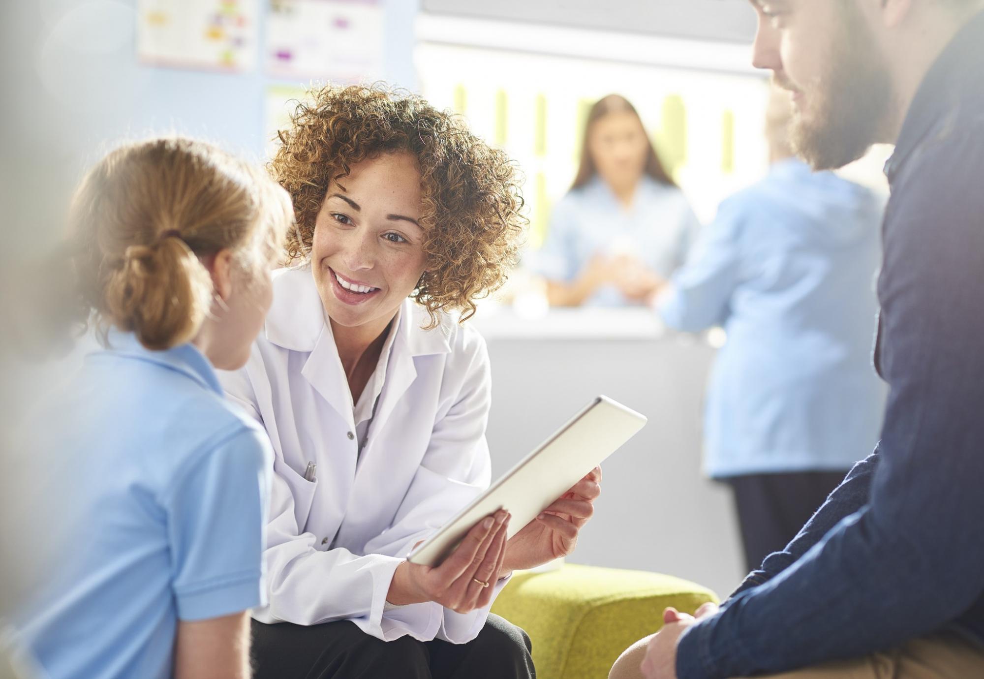 Female health professional talking with a young girl