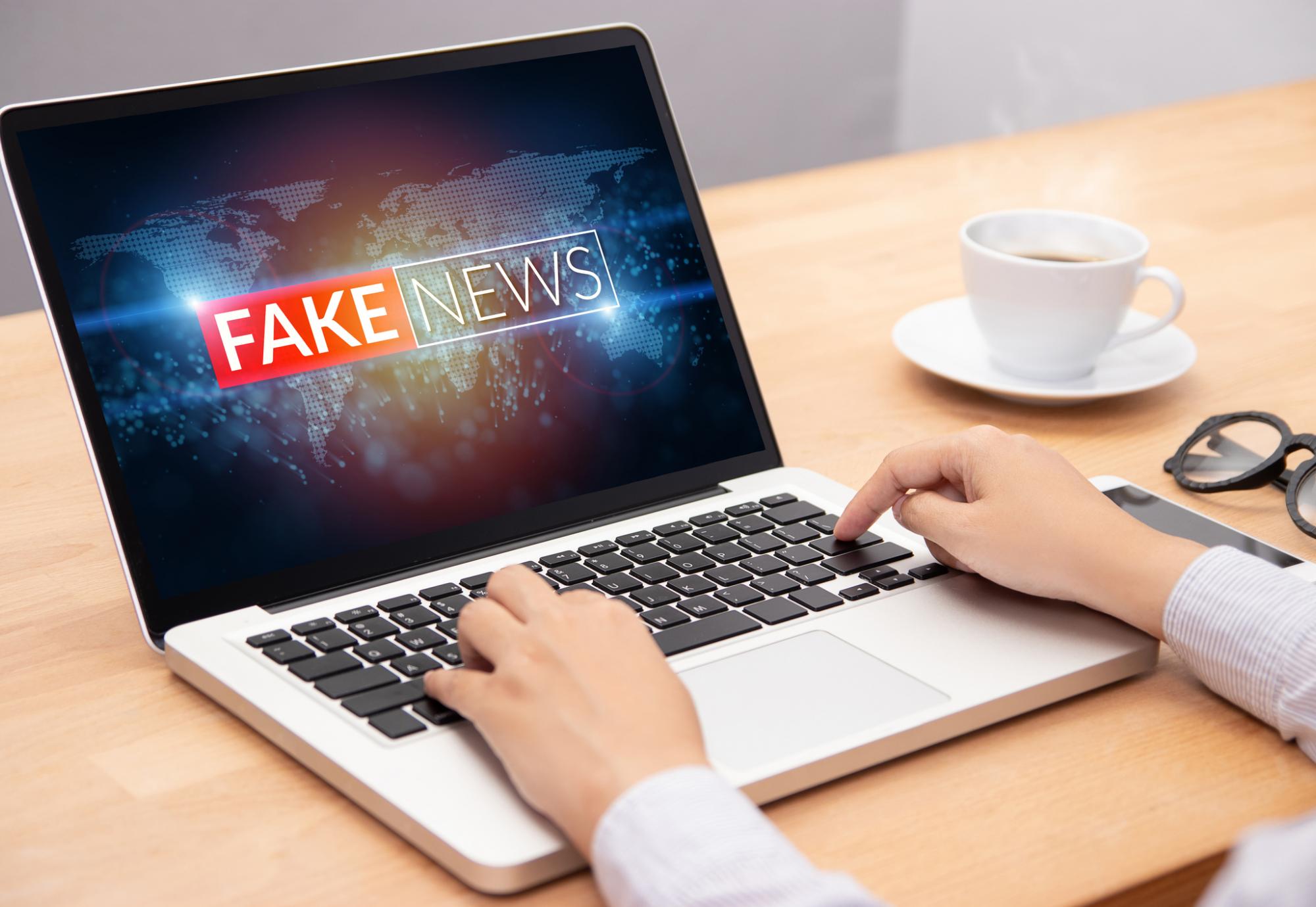 Man looks at fake news on his computer