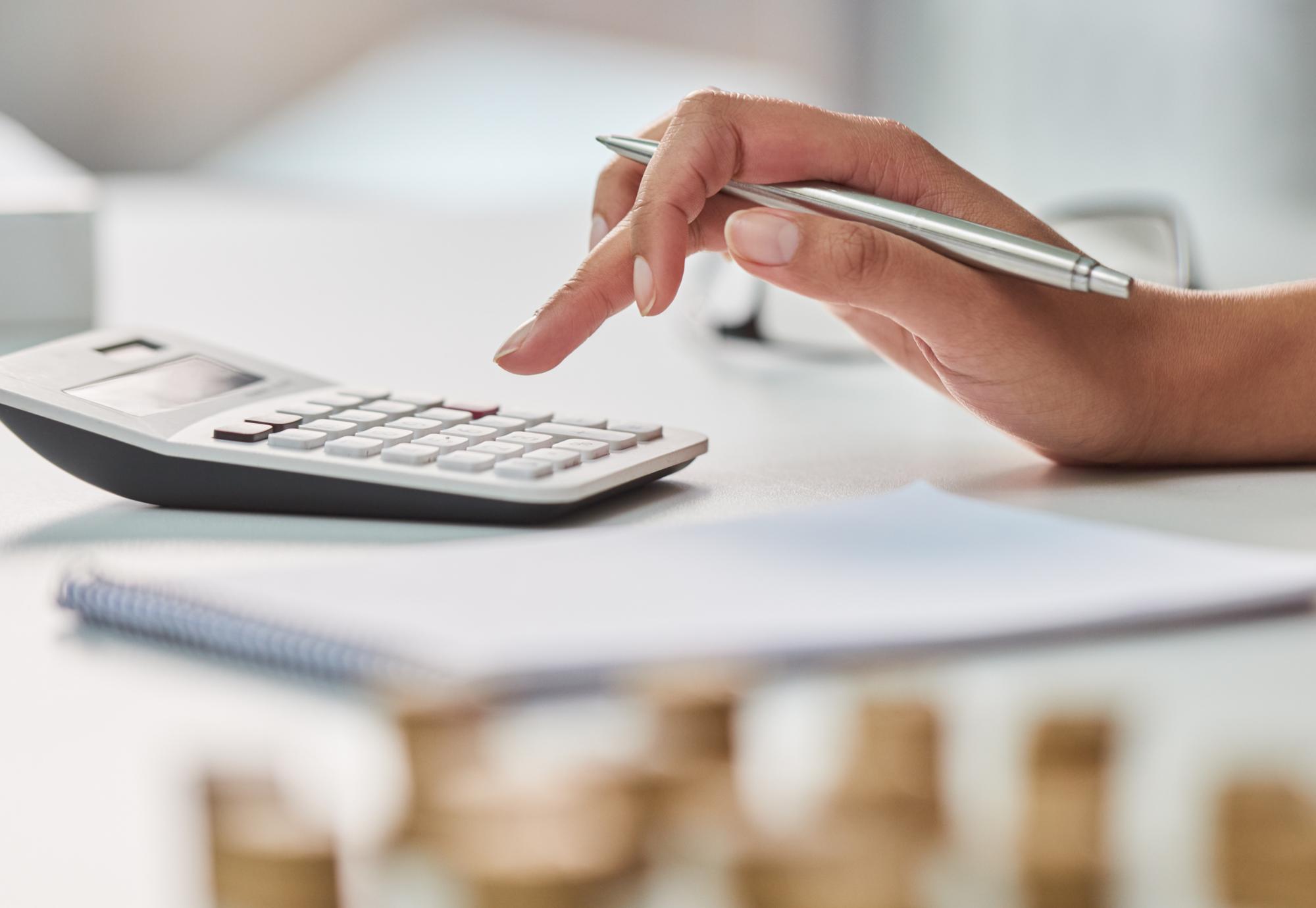 Woman uses calculator to work out her finances