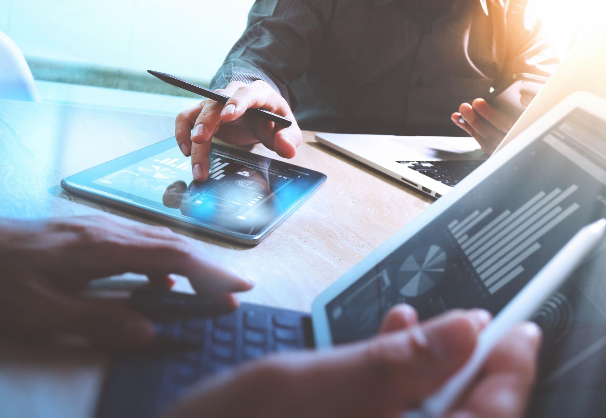 Group of business people make plans on tablets