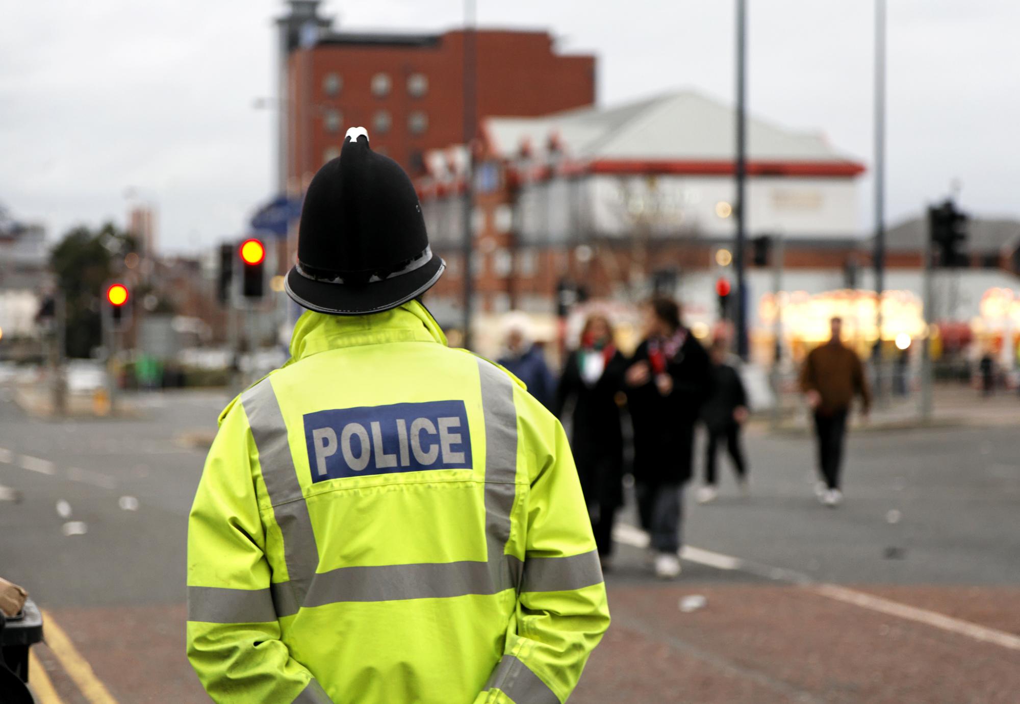 Police man stands guard in the street. 