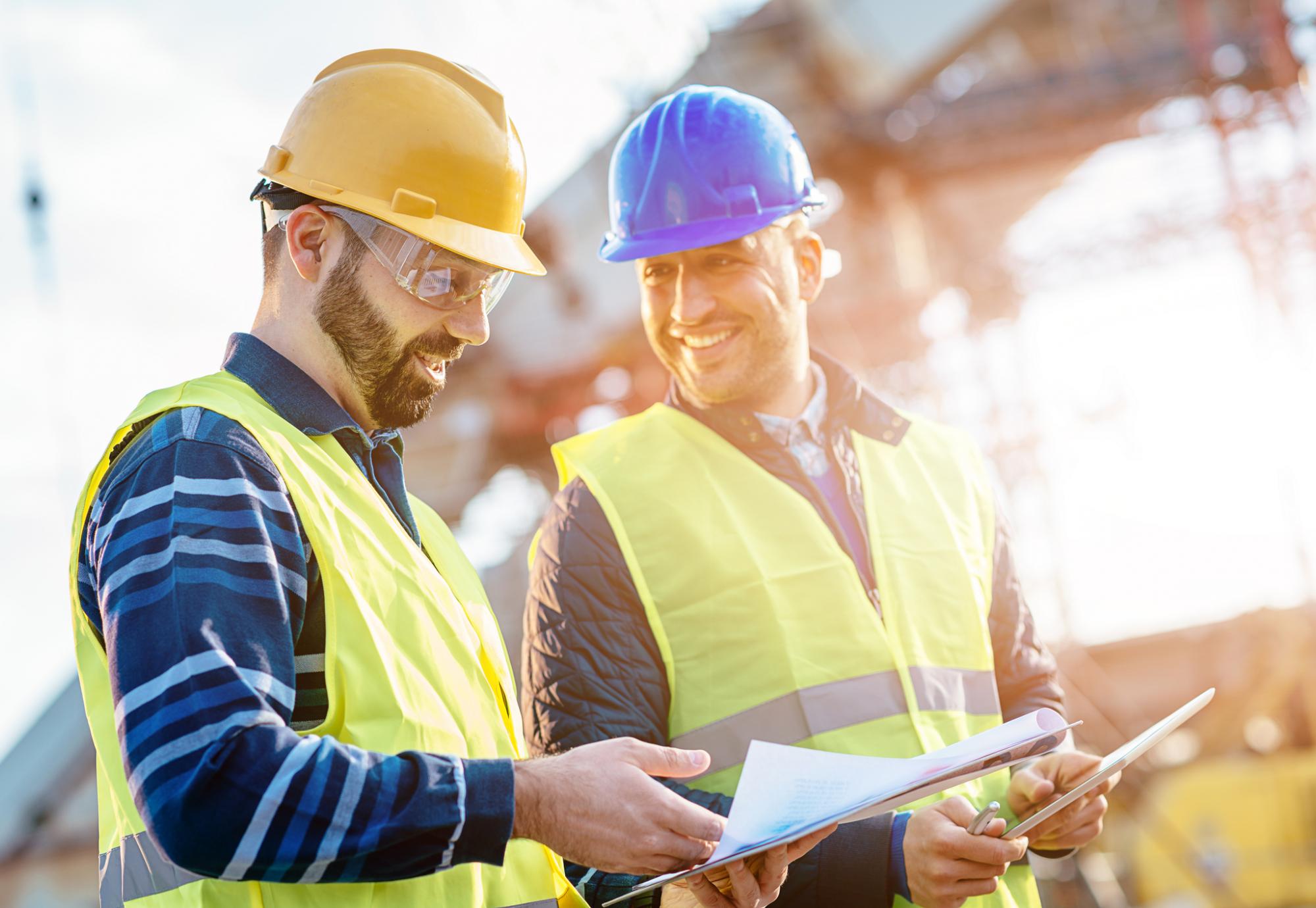 Construction workers discussing on a building site