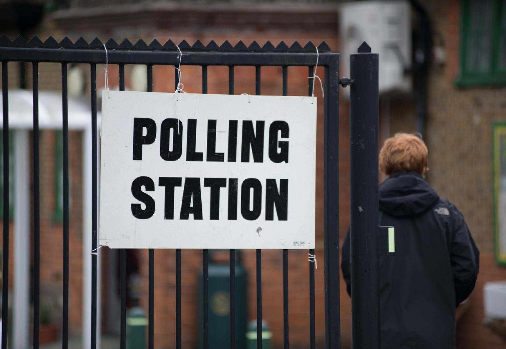 Man walks in to polling station. 