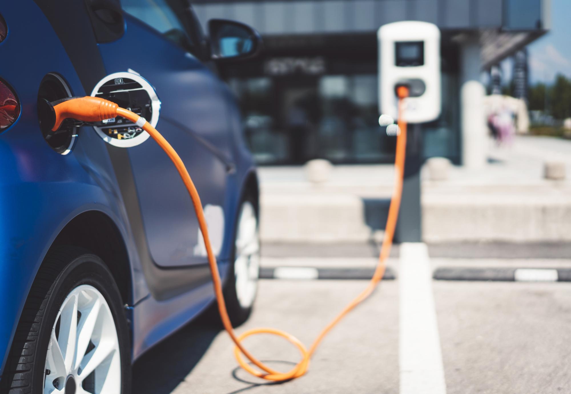 Electric vehicle parked up and charging