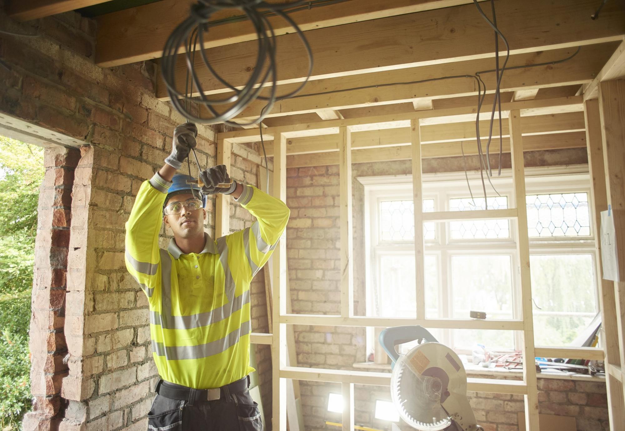 Electrician wiring up a newly built house