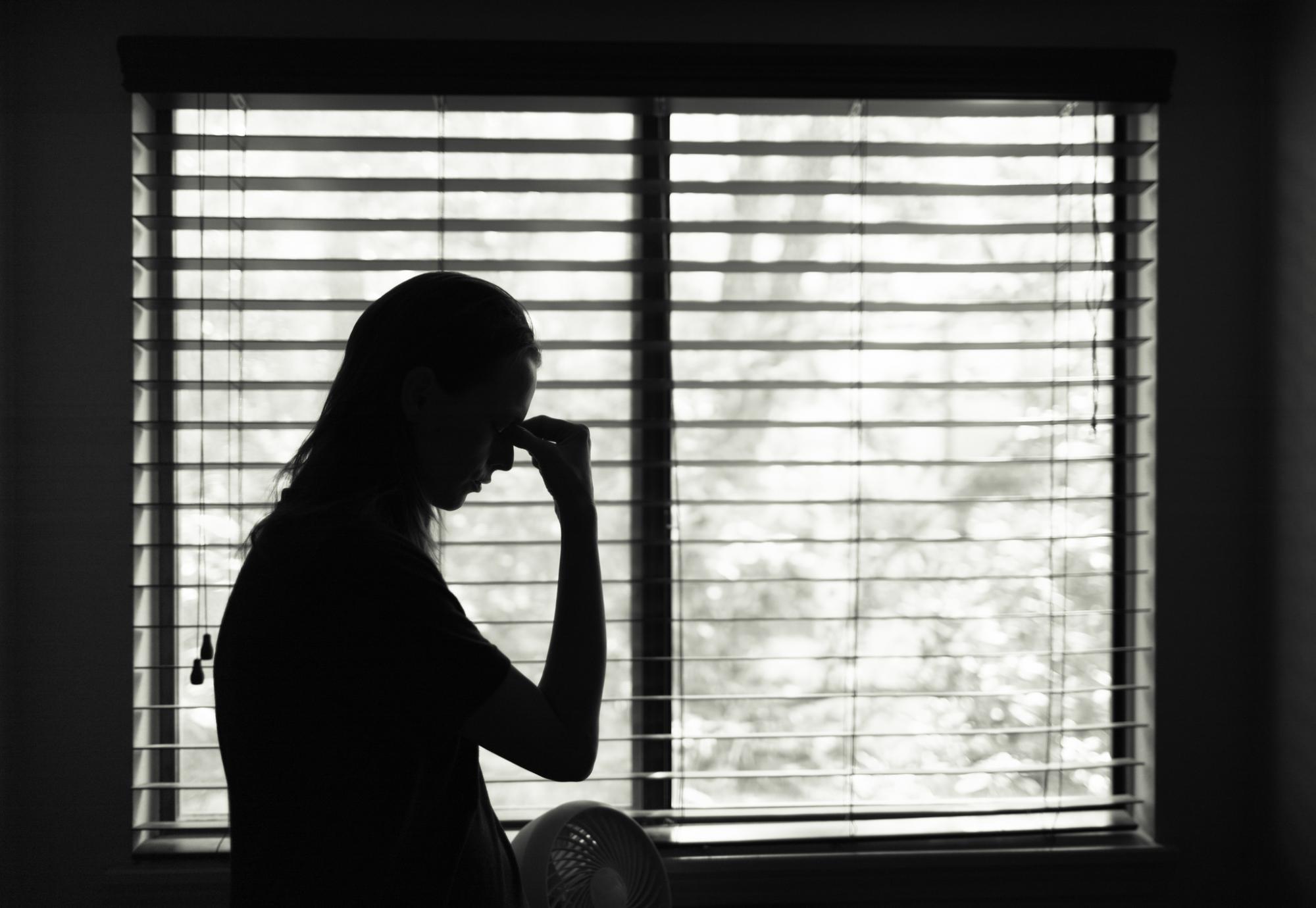 Woman sitting in bedroom