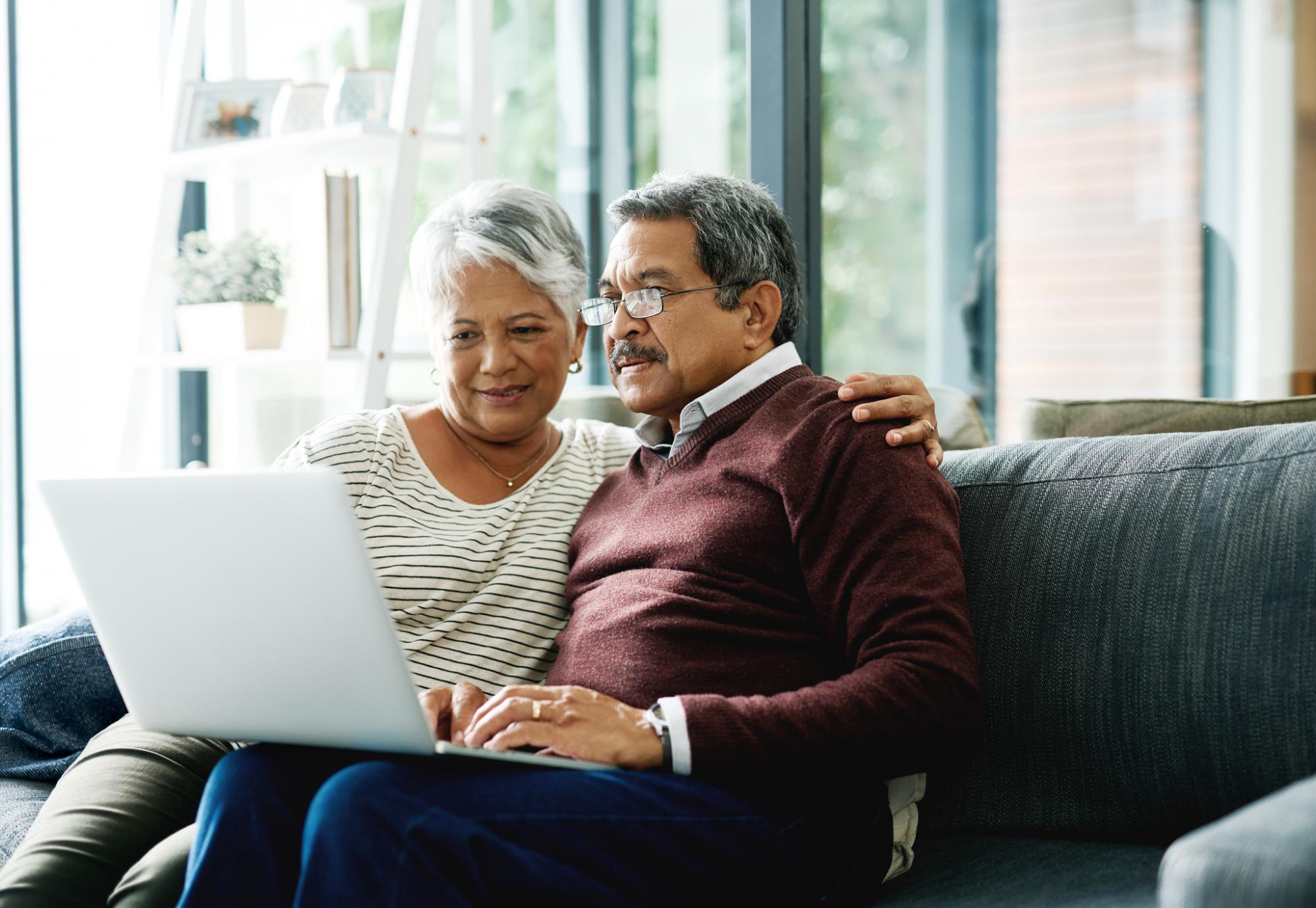 Elderly couple on laptop at home