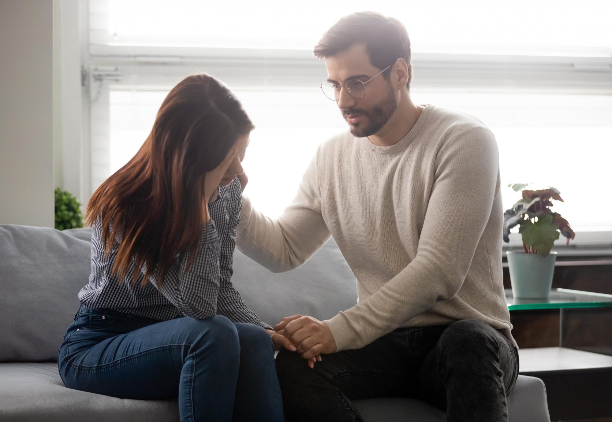 Man consoling woman