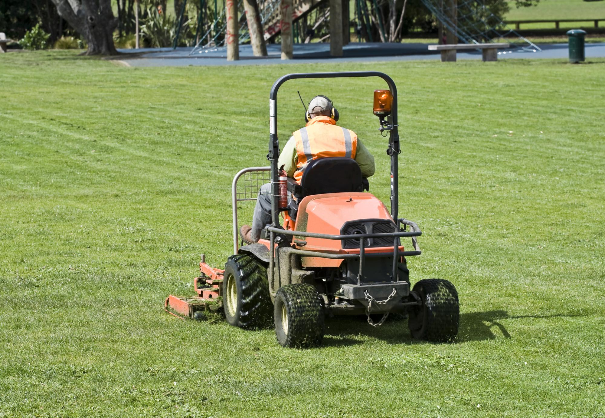 Man cutting grass on lawn moer