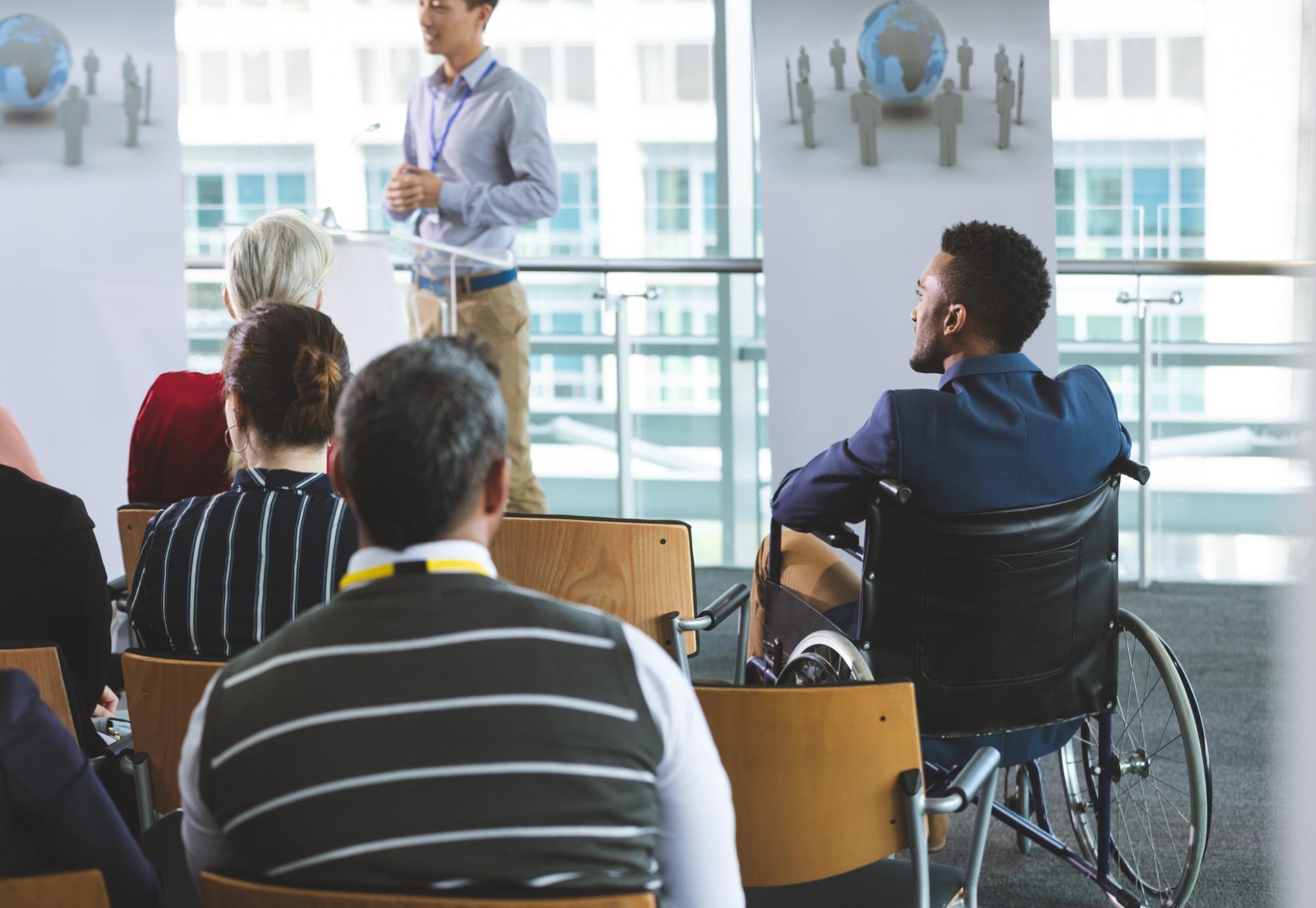 Man in wheelchair at business meeting