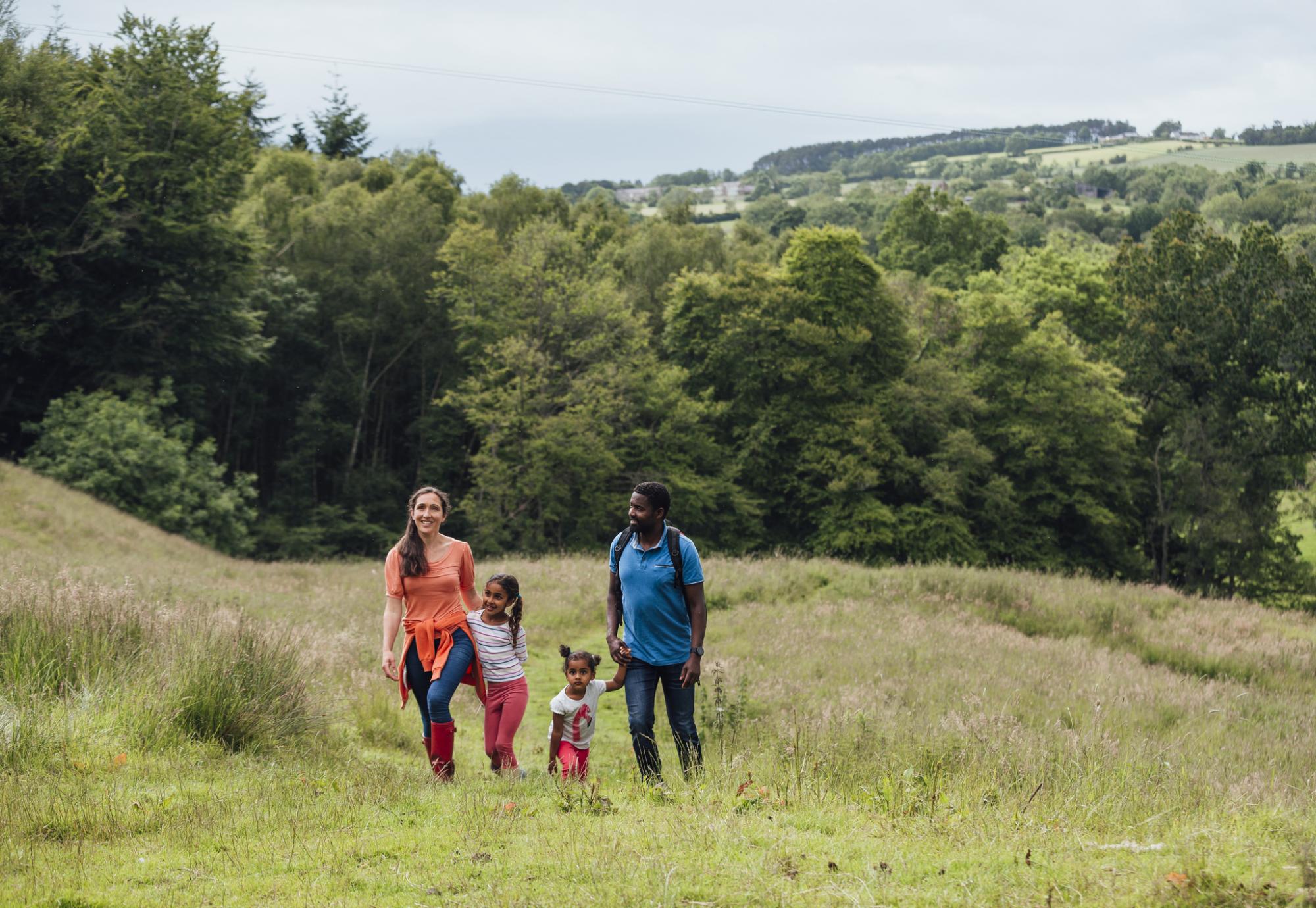 Northumberland trees with family walking