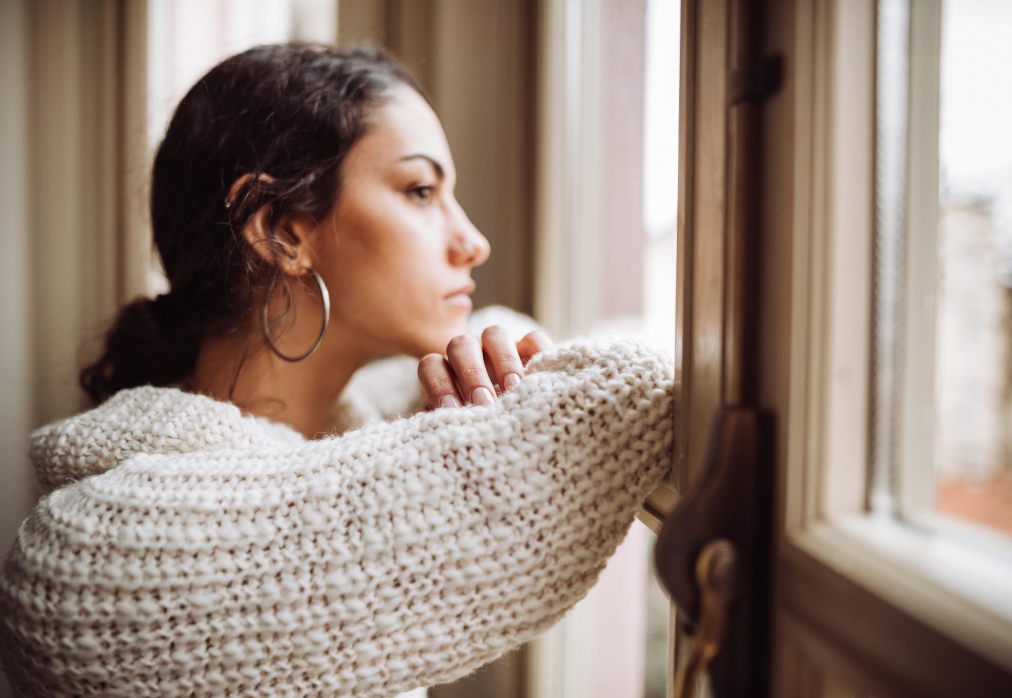 Young woman looking out window