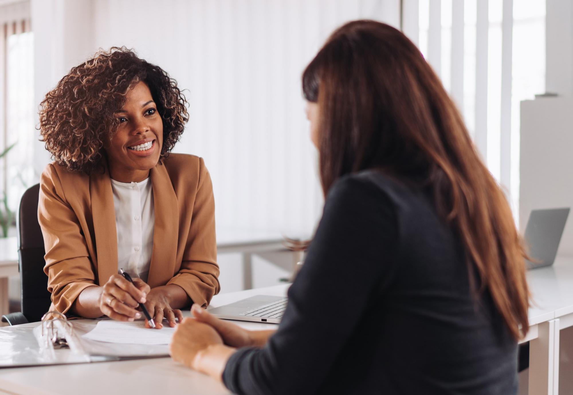 Youth worker offering careers advice to a young woman