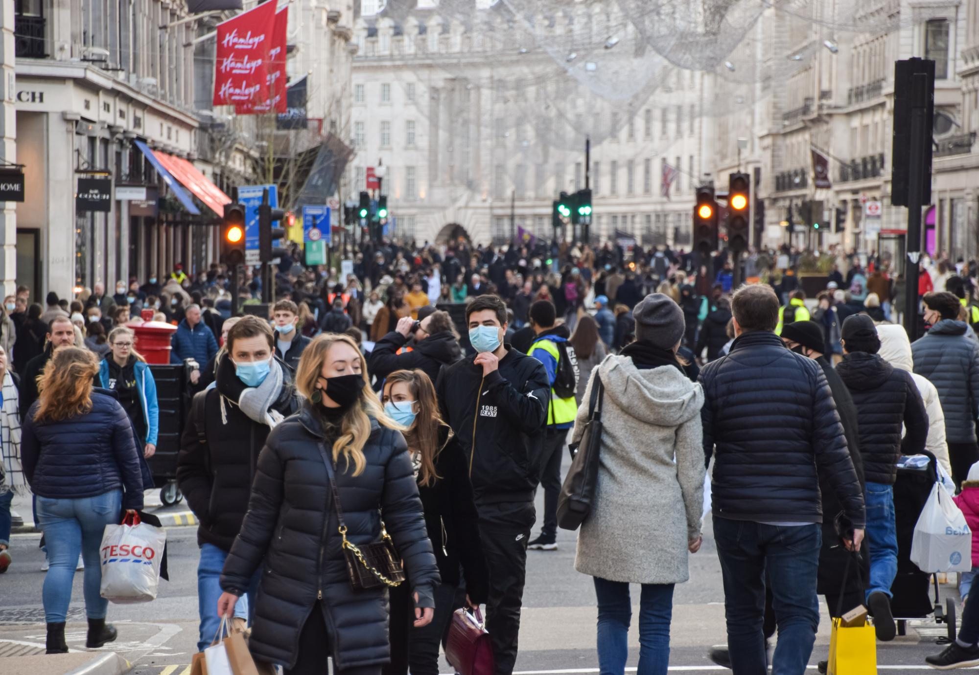 Busy London street with shoppers wearing face masks