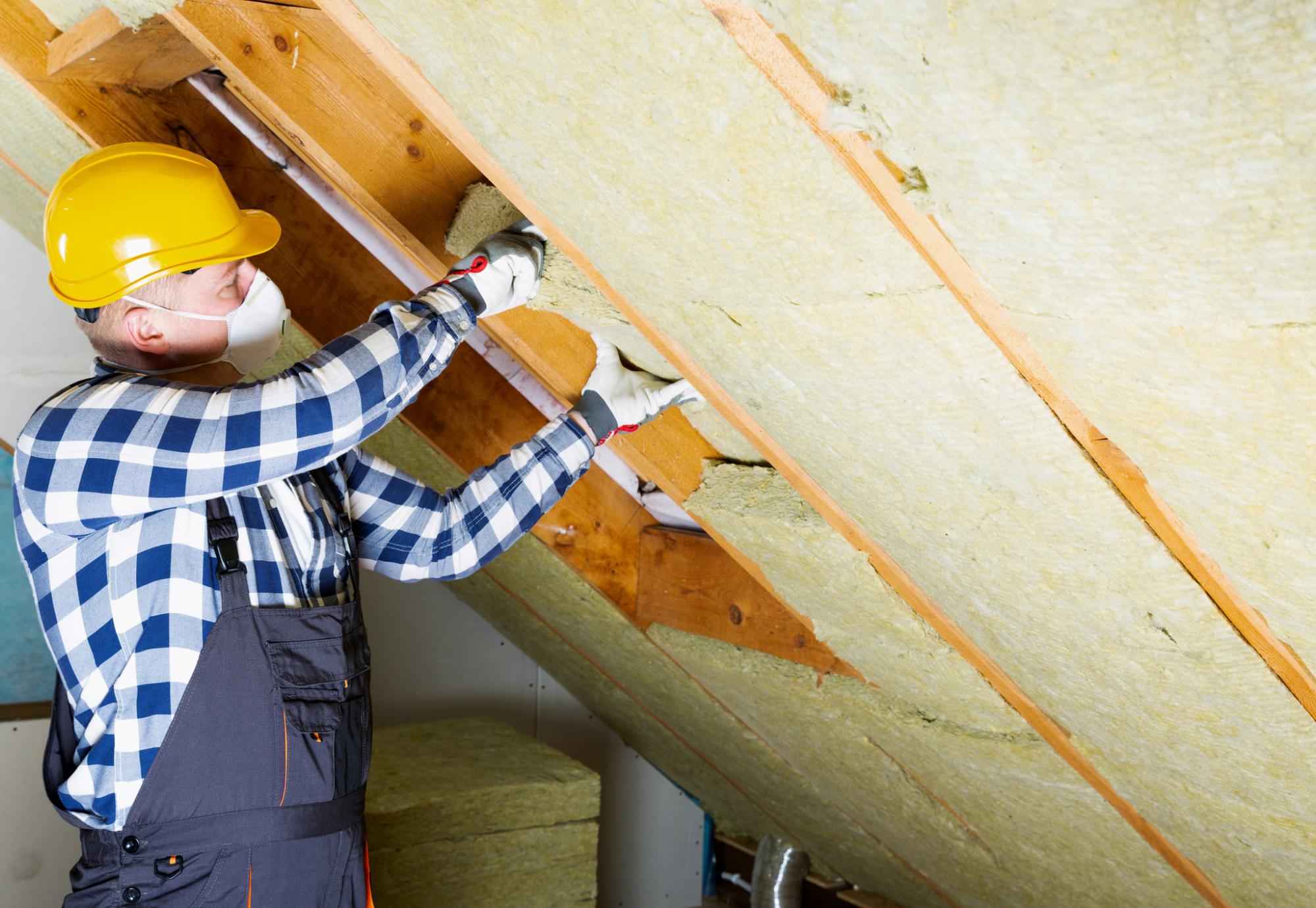 Man installing roof insulation