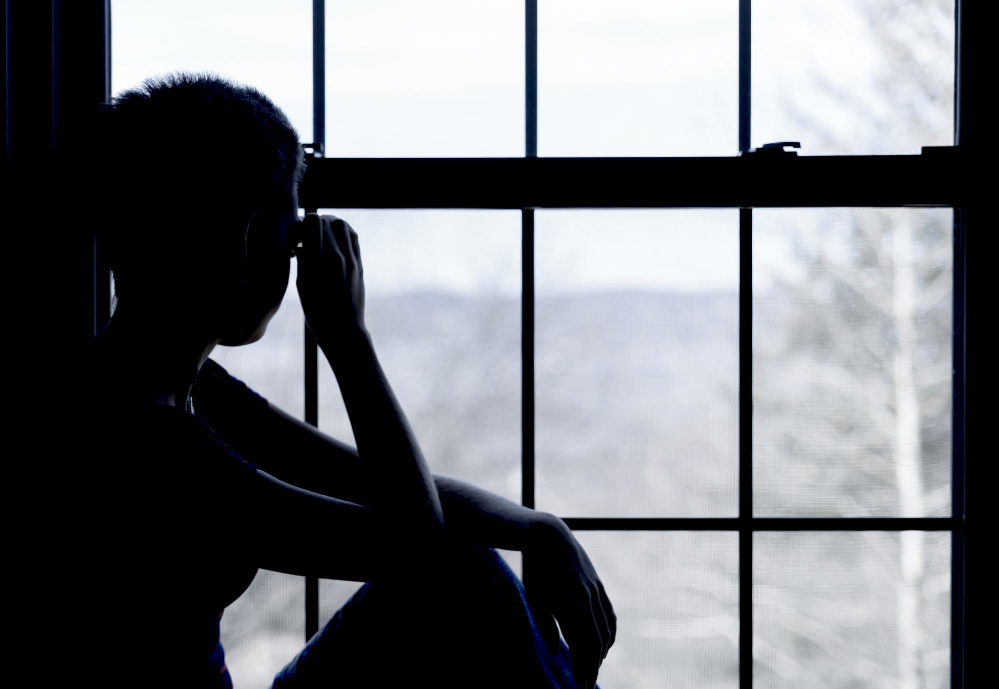 Woman looking out window