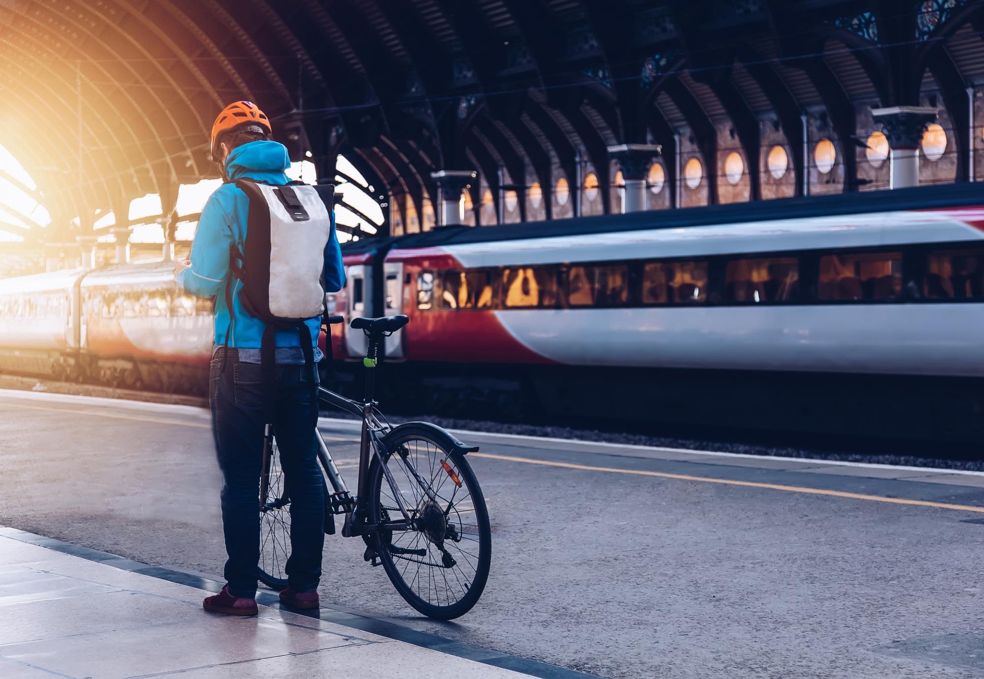 Man and bike, with train in background
