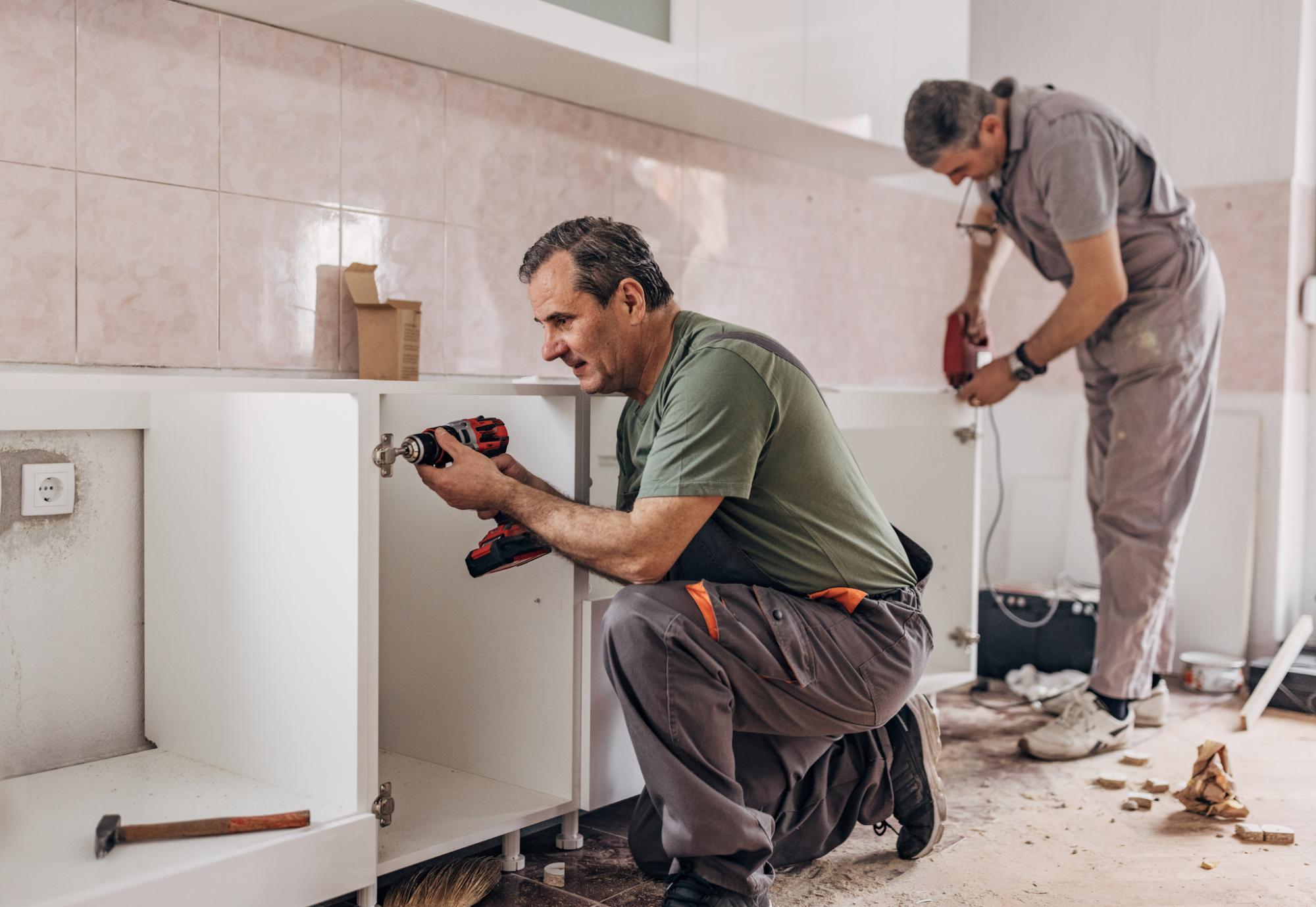 Kitchen being fitted in a council house