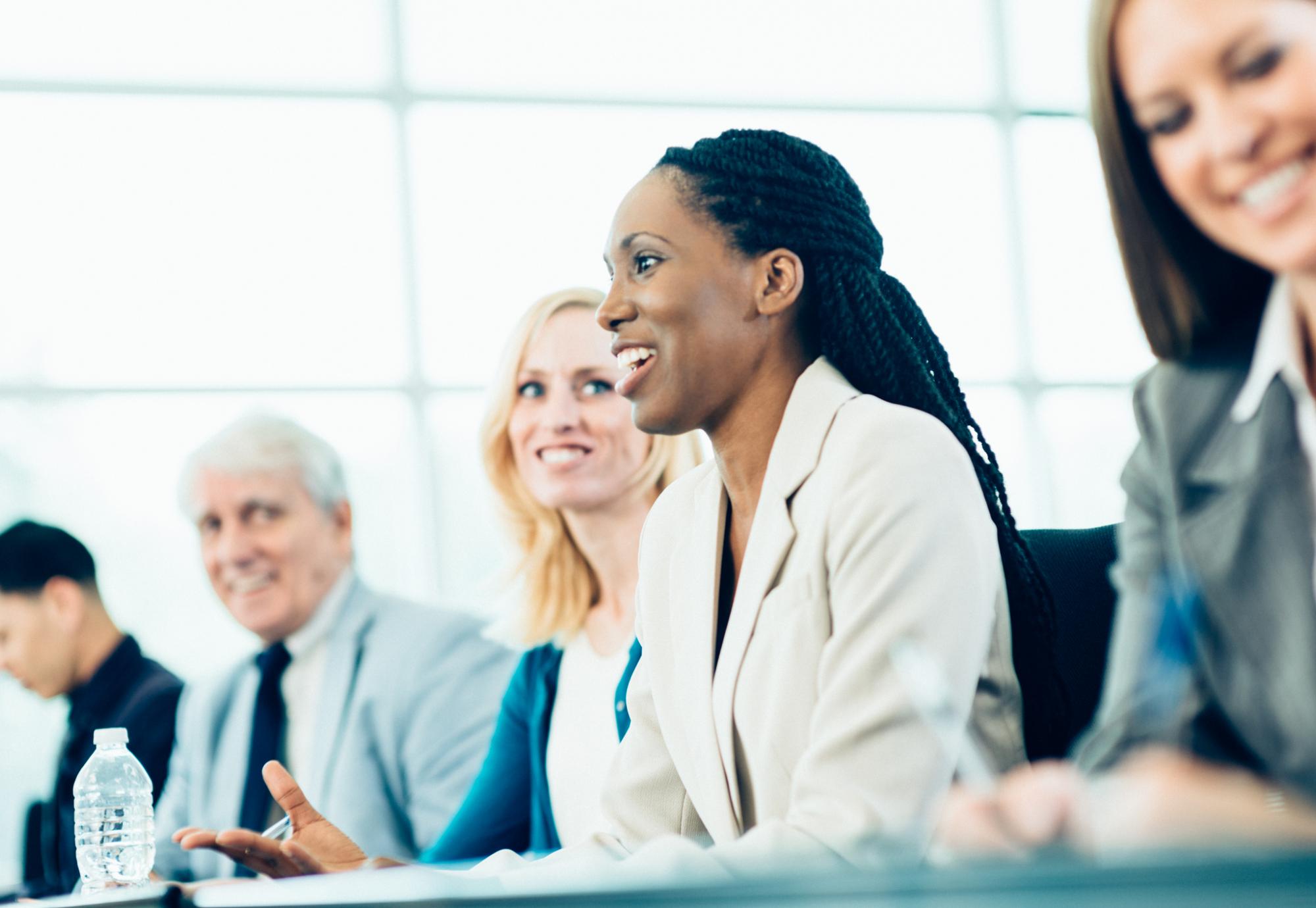 Woman on a panel talking at a meeting