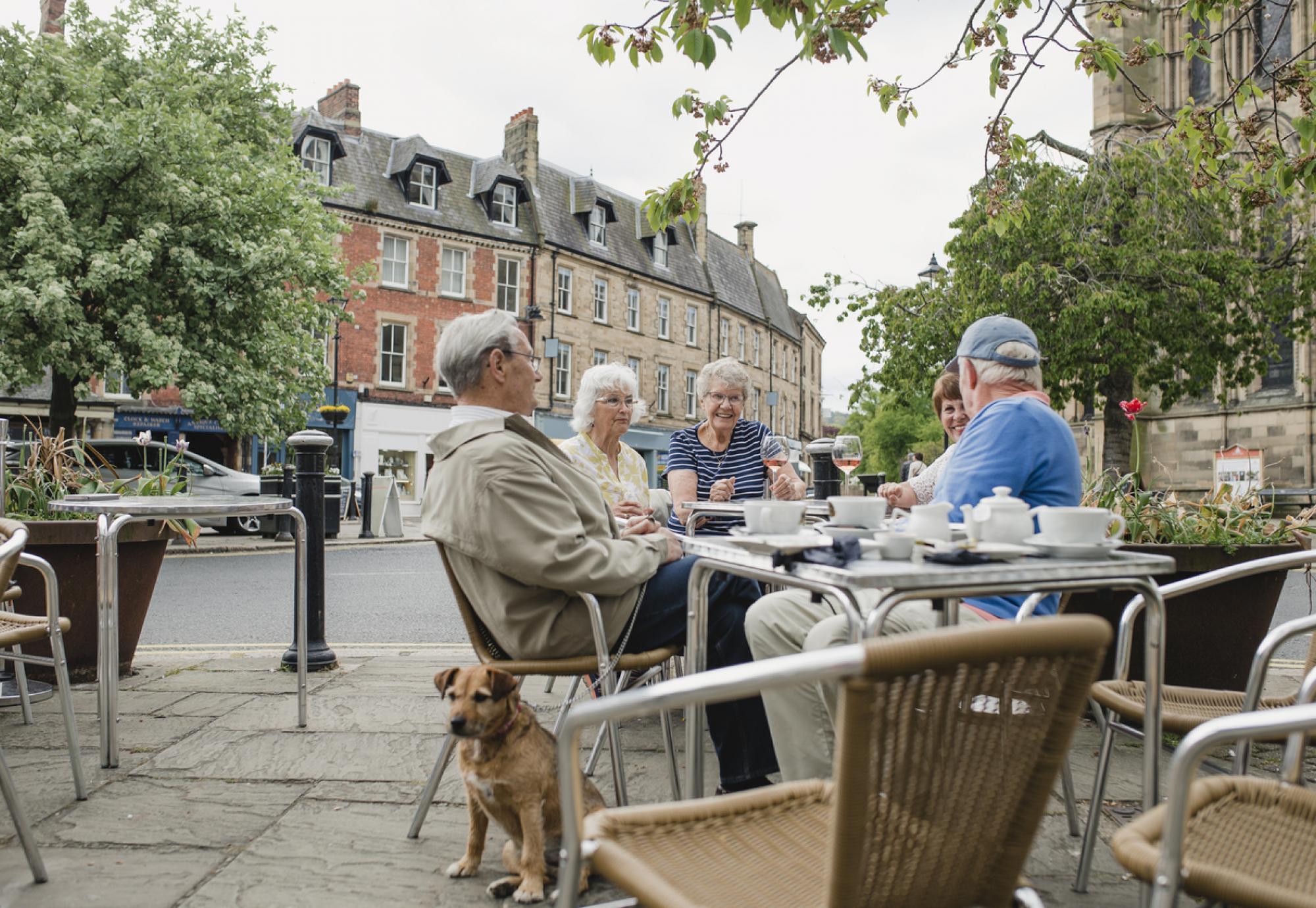 People sit outside a cafe in Hexham town centre
